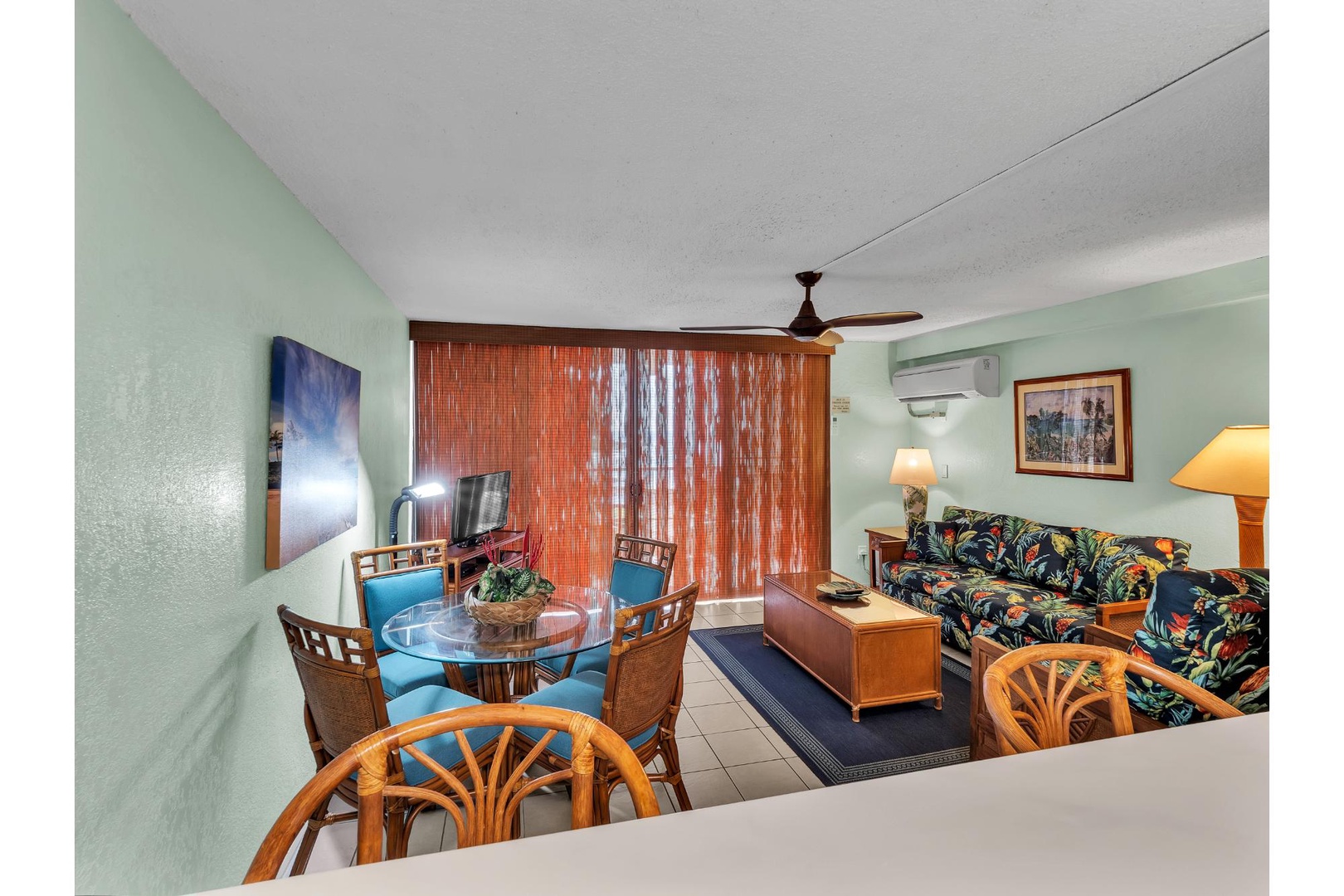 Relax in your tropical-themed living space with bamboo accents, comfortable seating, and island-style decor that creates the perfect vacation atmosphere.