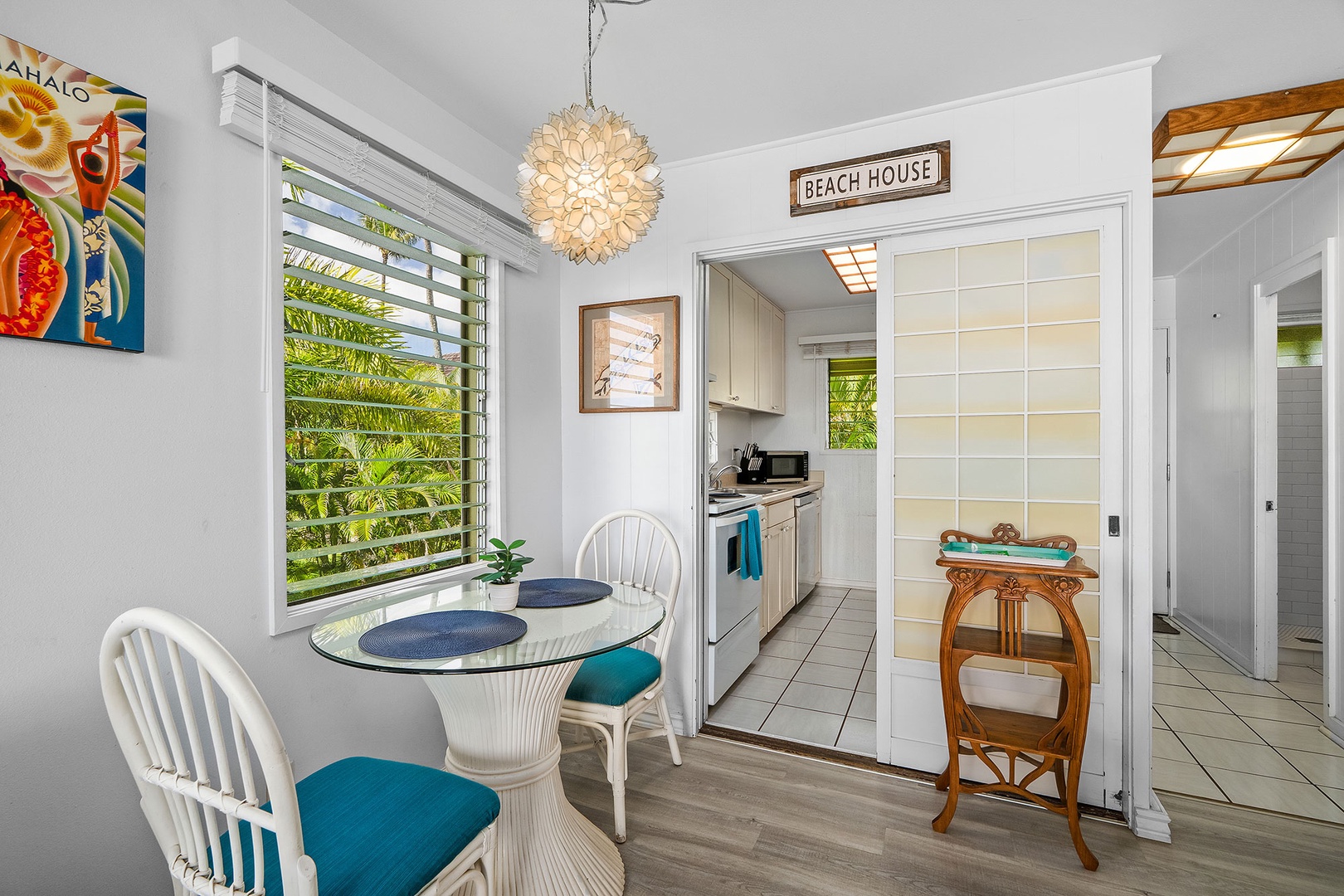 Your bright dining space opens to the tropical kitchen, where island breezes flow through louvered windows as you enjoy meals.