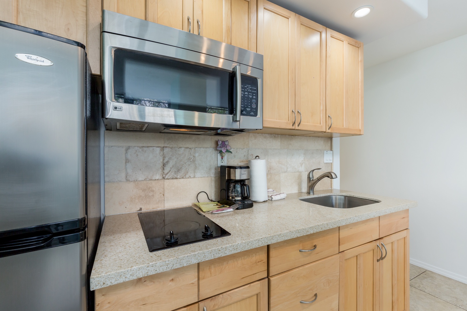 Your fully equipped kitchen features modern appliances, warm wood cabinetry, and ample counter space for preparing your favorite meals during your stay.