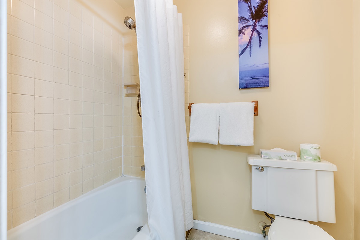 Your private bathroom features a tub-shower combo with fresh towels and complimentary toiletries to refresh after adventures.