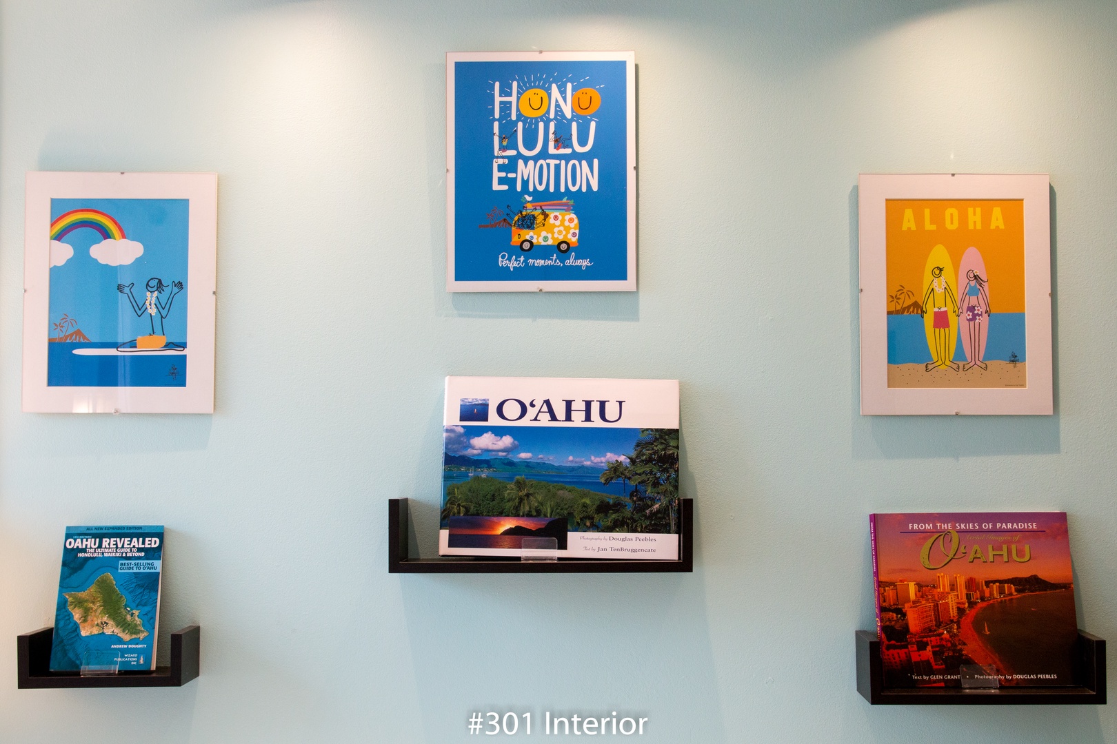 Bright Hawaiian prints and travel books add island charm to your space, inviting you to unwind and dream of tropical adventures.