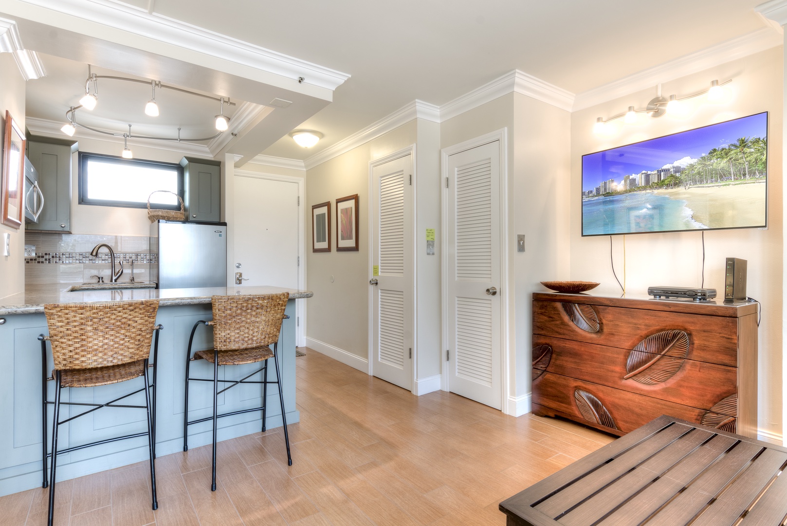 Unwind in your bright, open living space featuring a fully equipped kitchen with breakfast bar, stylish island seating, and a cozy entertainment area—your perfect home base for relaxing.