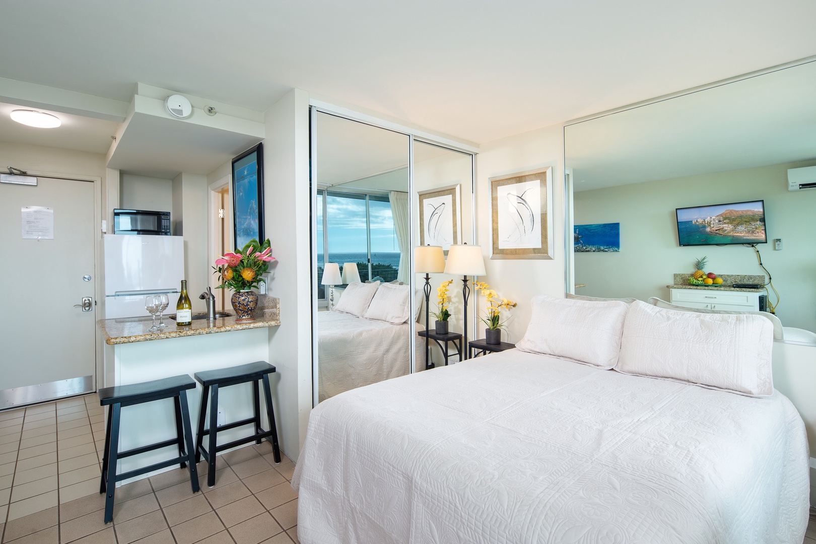 Your bright, airy studio welcomes you with crisp linens, ocean-view mirrors, and a cozy breakfast bar—perfect for unwinding after beach days.