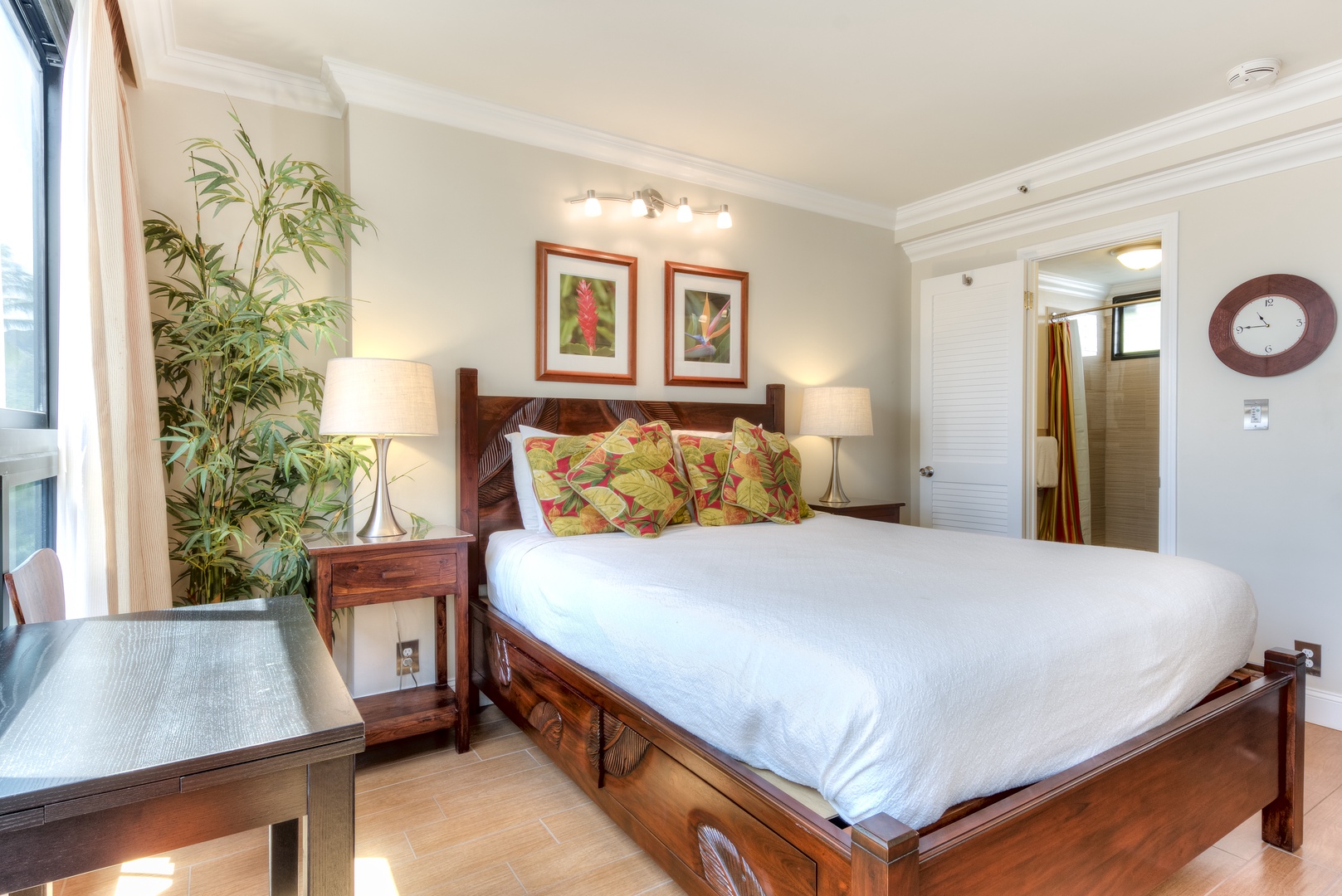 Slip into crisp linens and let tropical accents transport you to relaxation mode—your restful retreat with warm wood tones and vibrant touches awaits.
