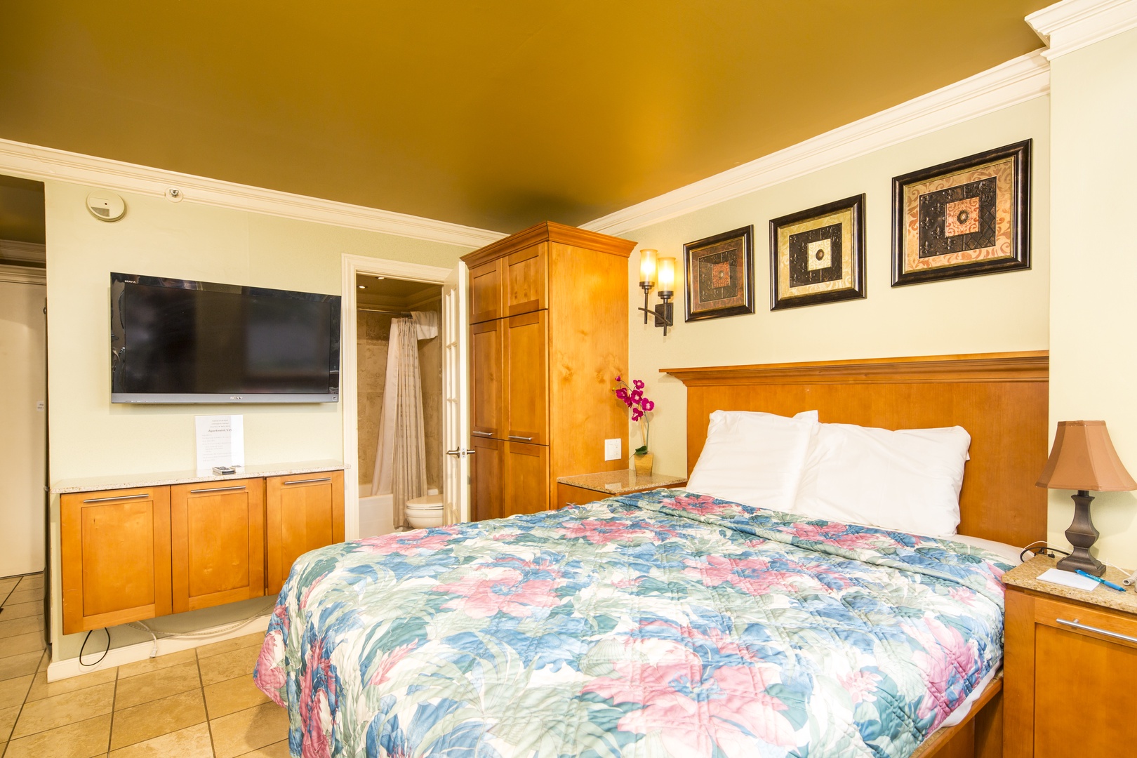 Relax in comfort with a plush bed, warm wood furnishings, and modern amenities like a flat-screen TV to make your stay truly restful.