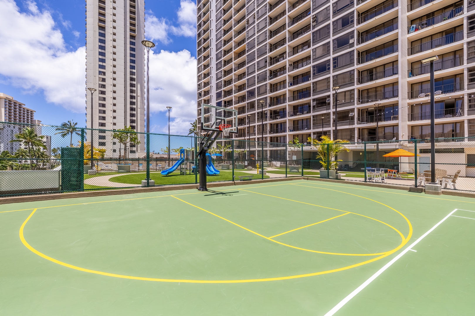 Enjoy a friendly game on the property's outdoor basketball court, complete with playground views and city surroundings. Perfect for staying active during your vacation.