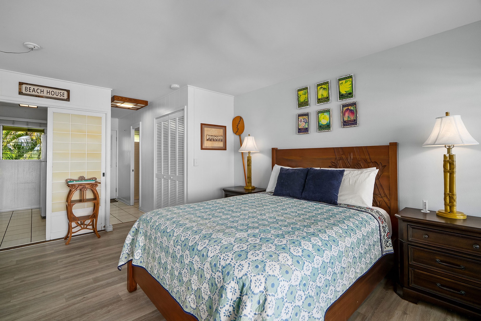 Unwind in your coastal sanctuary with comfortable bedding, beach-themed decor, and warm lighting creating the perfect retreat.