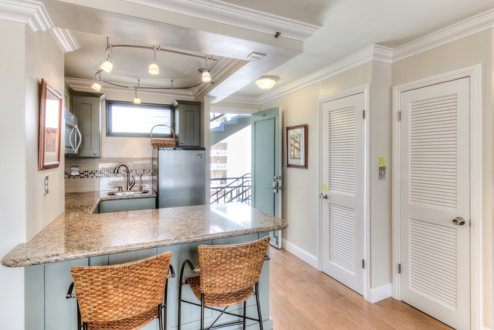 Gather at the breakfast bar with granite countertops and coastal charm, where your mornings start with style and modern appliances are at your fingertips.