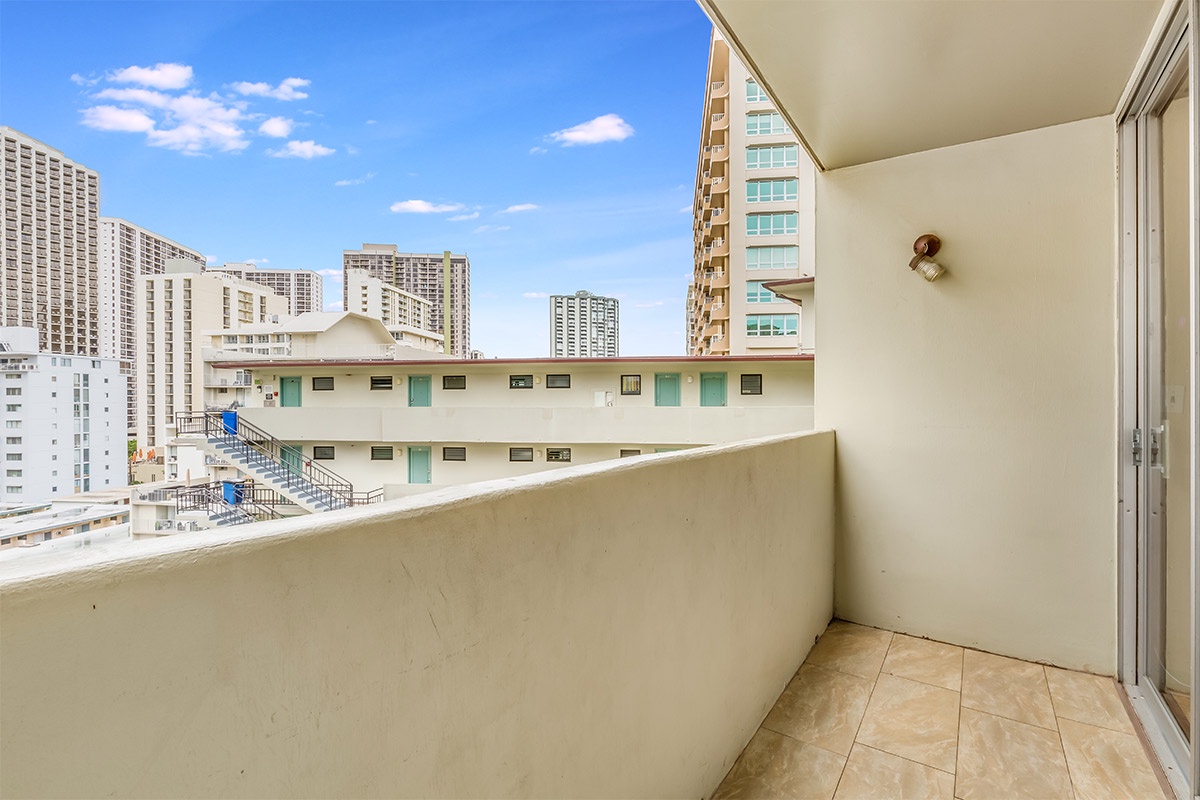 Private balcony with urban city views, perfect for morning coffee or evening relaxation surrounded by Waikiki's vibrant skyline.