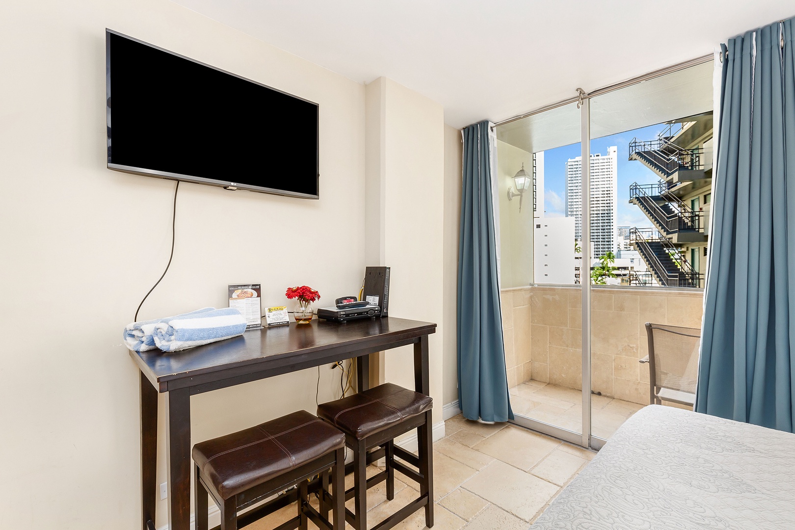 Your bright room features a flat-screen TV for relaxing evenings, a stylish desk for planning adventures, and a private balcony with city views to enjoy your morning coffee.