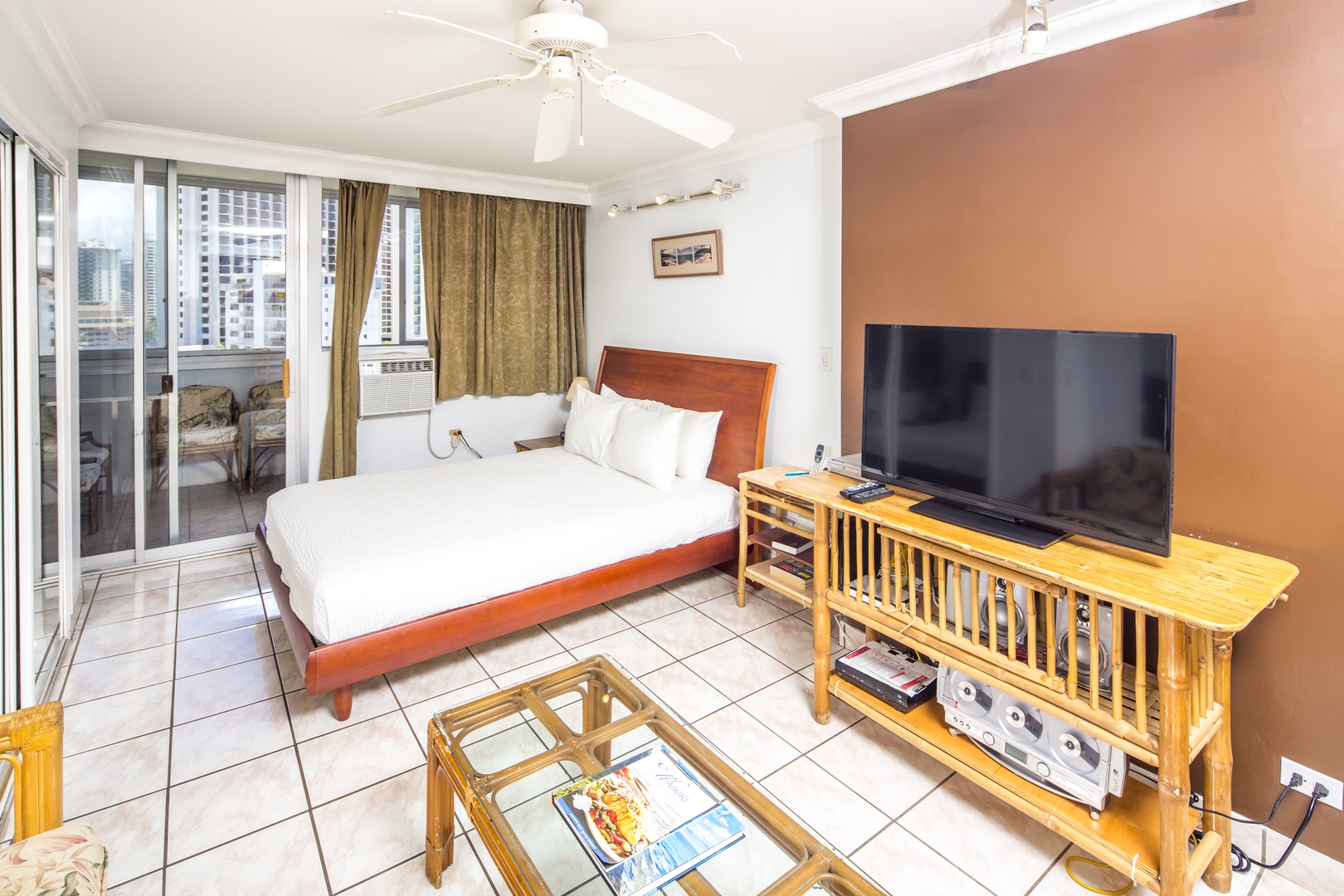 Unwind in your bright bedroom with a plush bed and private balcony overlooking the city. Enjoy your favorite shows on the flat-screen TV while the ceiling fan keeps you cool.