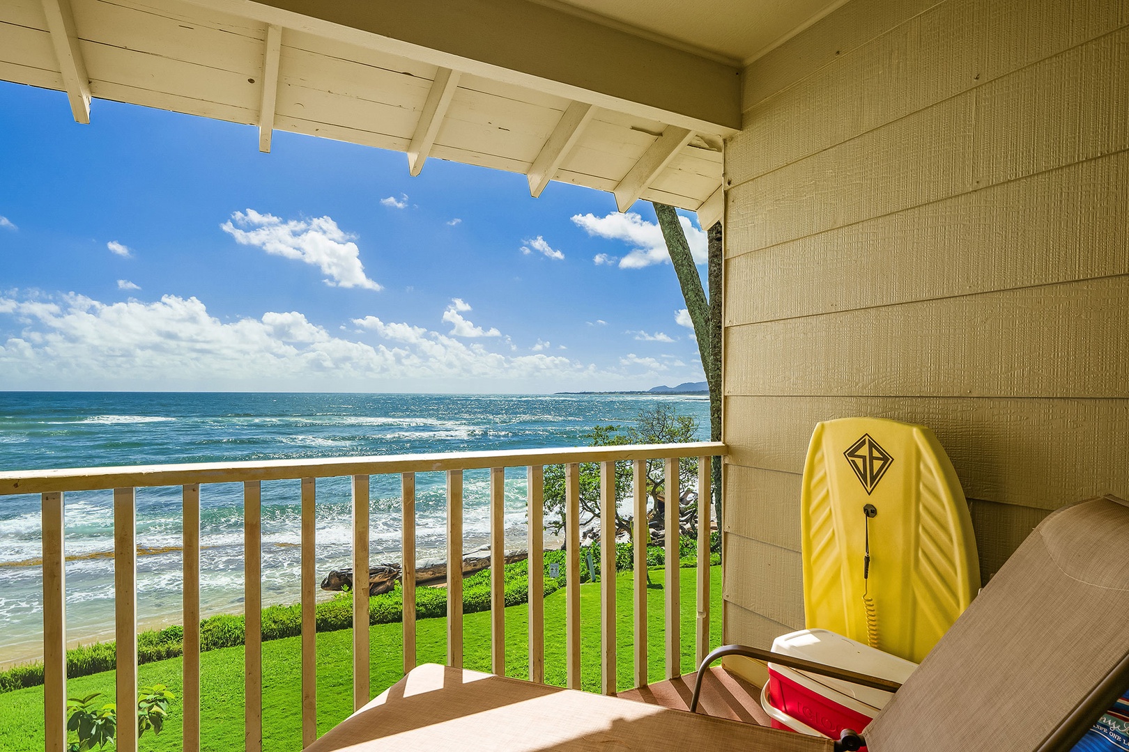 Relax on your private oceanfront balcony with breathtaking sea views and gentle waves below.