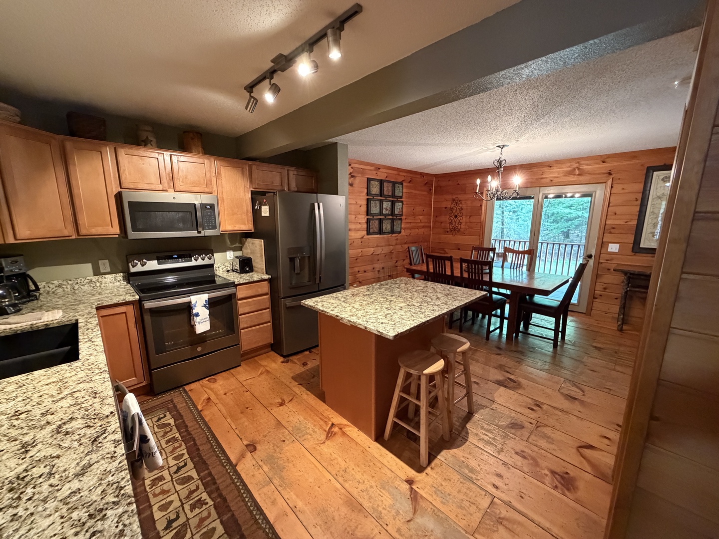 Picture yourself preparing meals in this spacious, fully-equipped kitchen with gleaming granite countertops and modern appliances, then gathering with loved ones at the adjacent dining table to share stories and laughter.