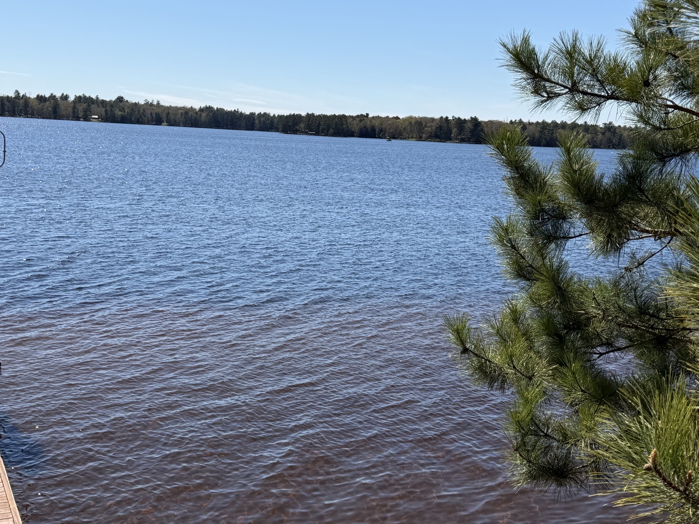 A serene lake framed by pine forests stretches across the property's surroundings, offering peaceful natural scenery and a tranquil escape.