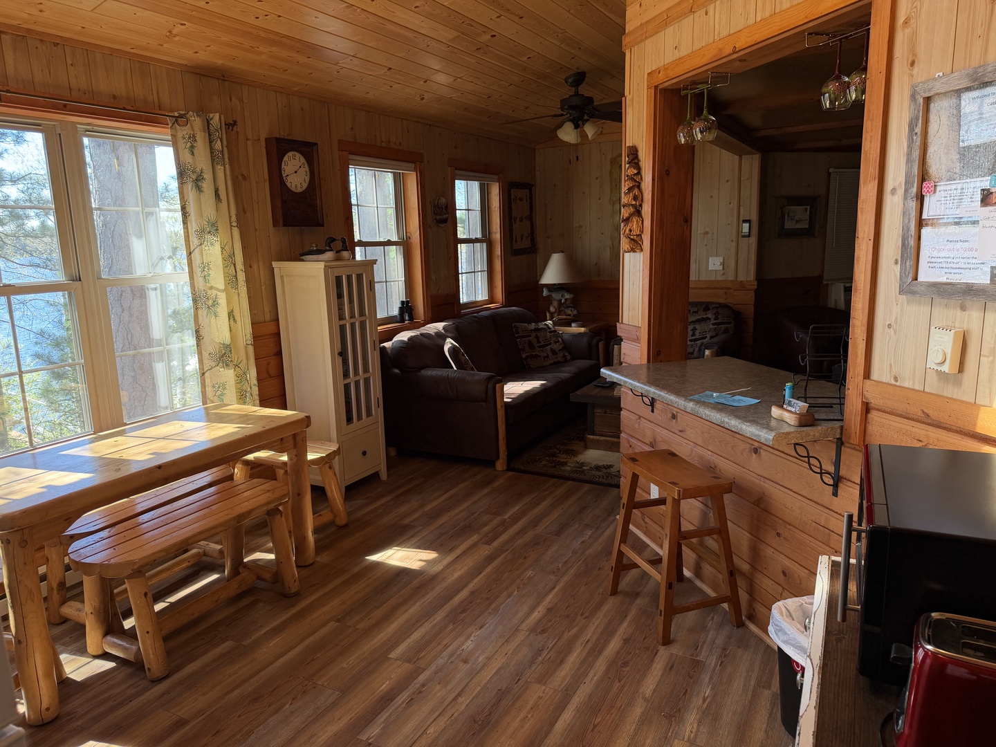 Relax in this cozy, sunlit cabin with rustic wood throughout. Your living and dining space flows into the kitchen, with lake views framing peaceful moments together.