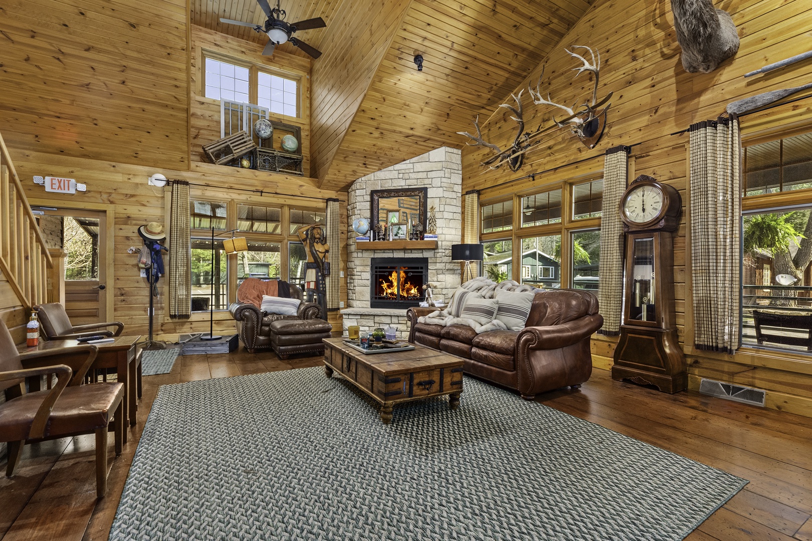 Sink into plush leather sofas beside a crackling stone fireplace in this soaring wood-paneled retreat, where rustic charm meets  elegance. Warm wood, natural light, and cozy furnishings invite you to truly unwind.