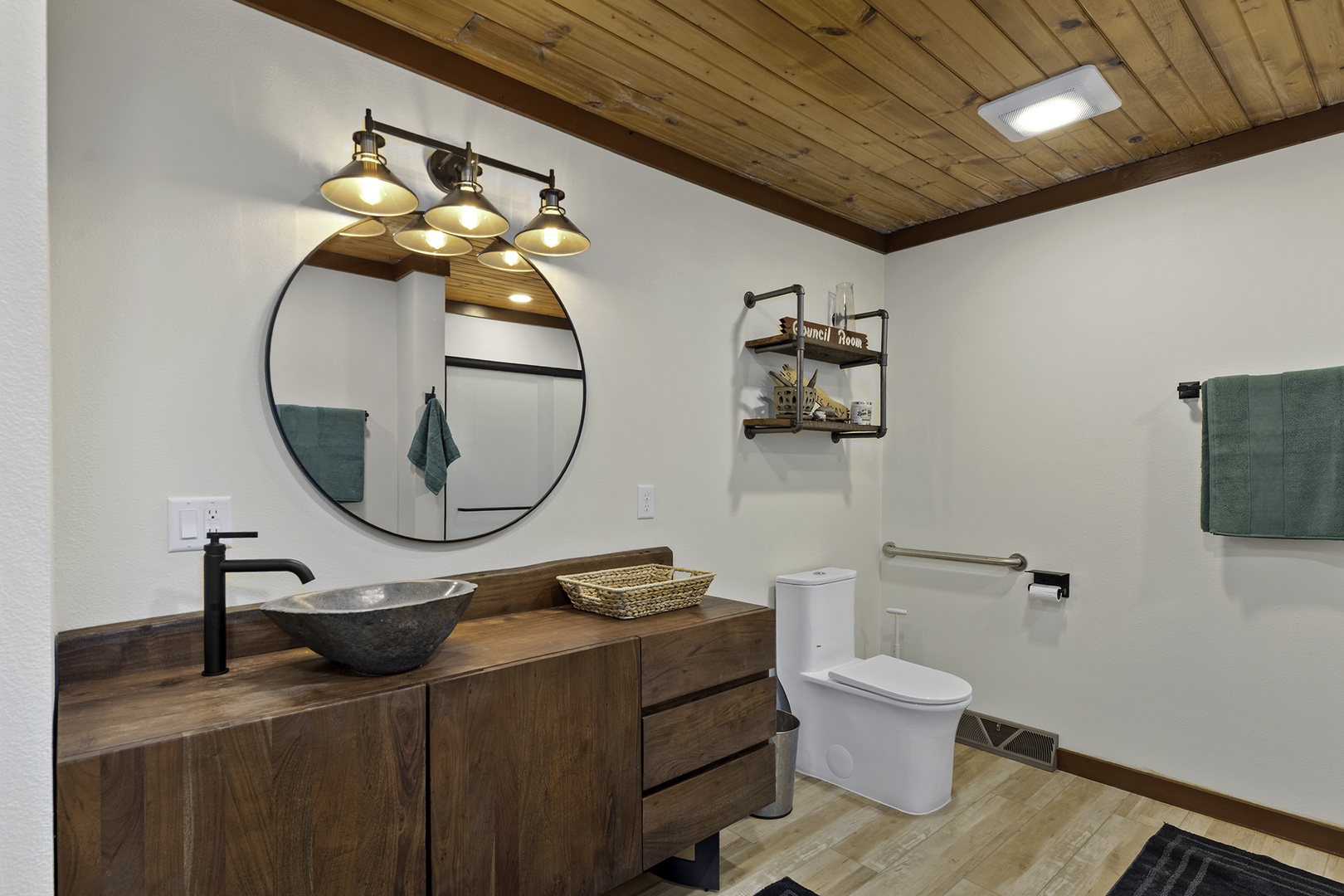 Your private bathroom combines rustic charm with modern comfort, featuring a striking vessel sink, warm wood accents, and thoughtful lighting to help you feel instantly at home.