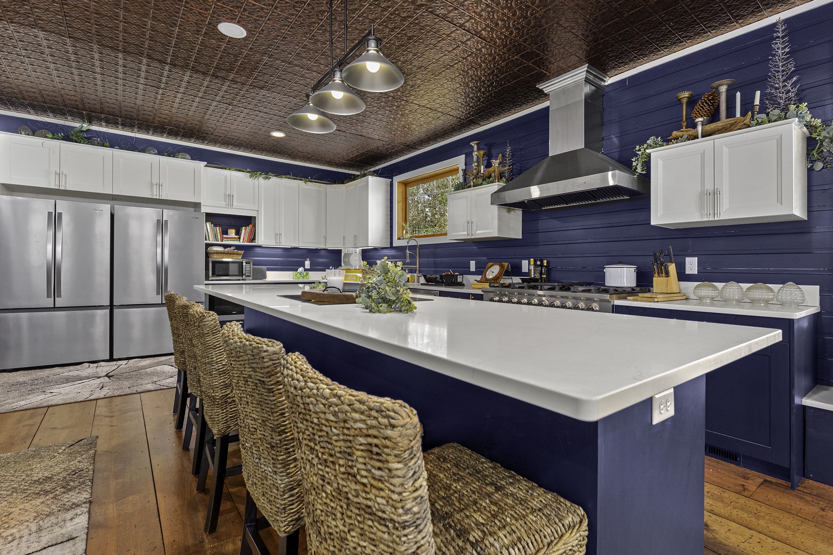 Picture yourself preparing meals in this stunning chef's kitchen with its spacious island, gleaming countertops, and top-tier appliances—your perfect home-away-from-home cooking space.