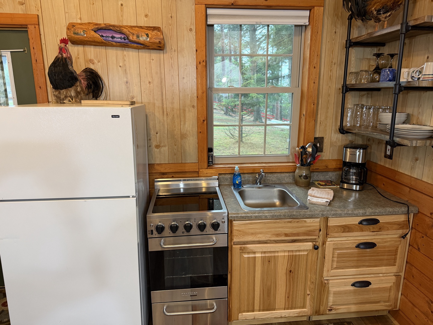 Your cozy kitchen features everything you need to whip up home-cooked meals, from the stove and full-sized fridge to charming country décor. Enjoy views of the peaceful green surroundings right from your window.
