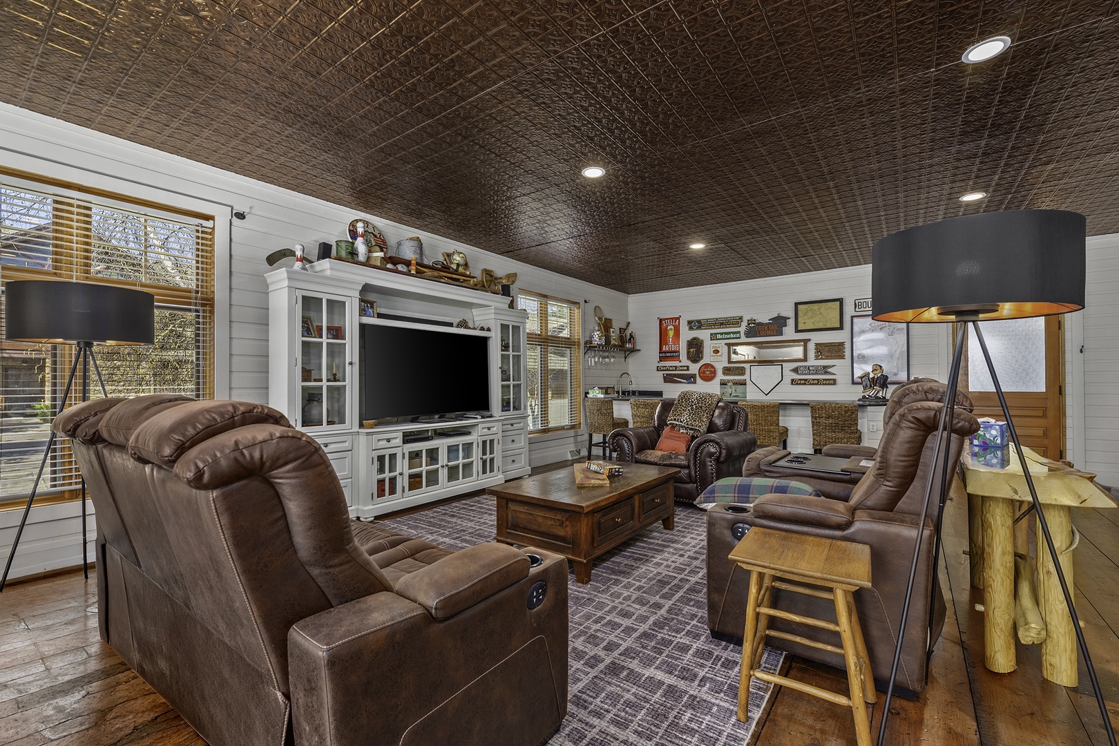 Sink into plush recliners and enjoy movie nights in your cozy living room, complete with a big-screen entertainment center and warm, rustic charm.