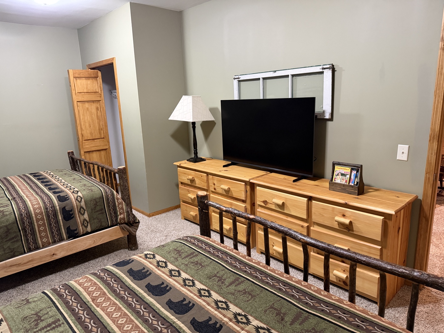Unwind in your cozy bedroom with two comfortable beds, rustic wood furnishings, and a flat-screen TV for your favorite shows after a day of adventure.