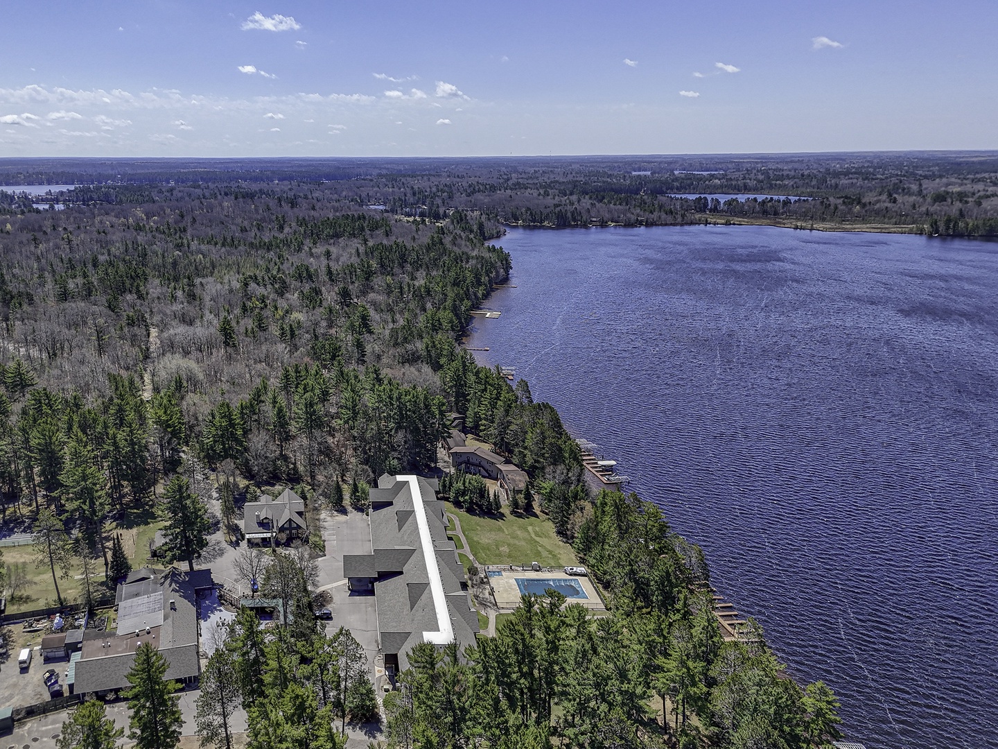 Expansive lakefront property nestled along pristine water, surrounded by forests and natural beauty—an ideal retreat destination offering privacy and scenic tranquility.