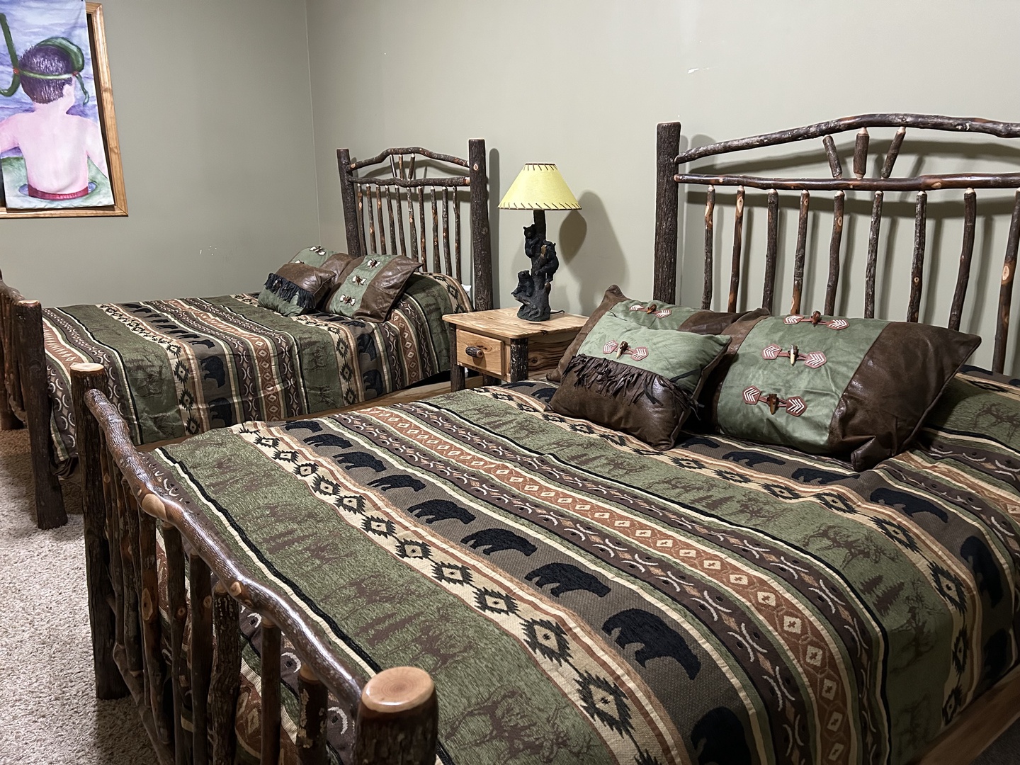 Cozy twin beds with rustic log frames and Native American-inspired bedding create your peaceful woodland retreat sanctuary.