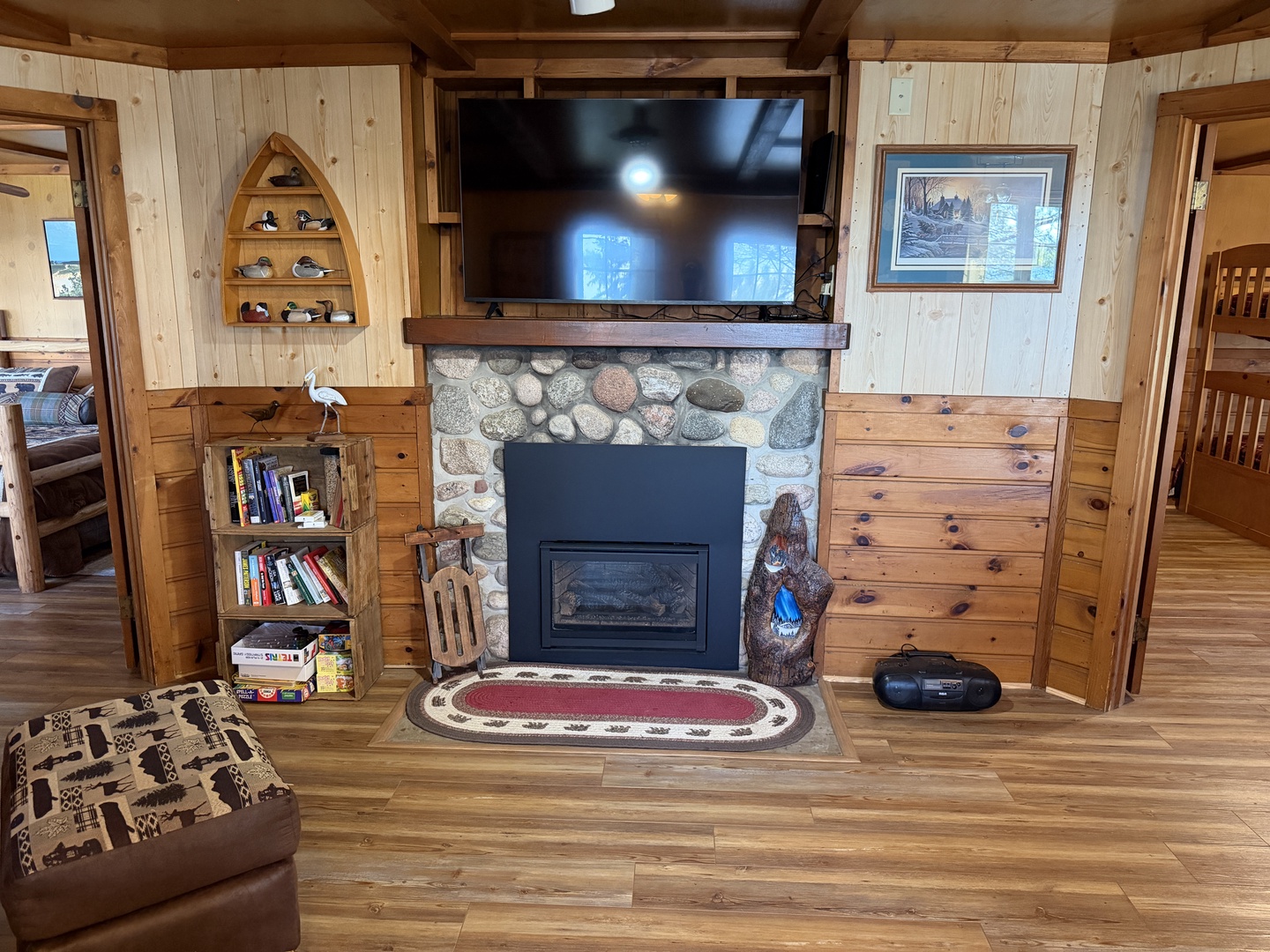 Unwind in this cozy living space where rustic wood paneling meets modern comfort. Warm up by the stone fireplace, enjoy your favorite shows on the mounted TV, and sink into plush seating after a day of adventure.