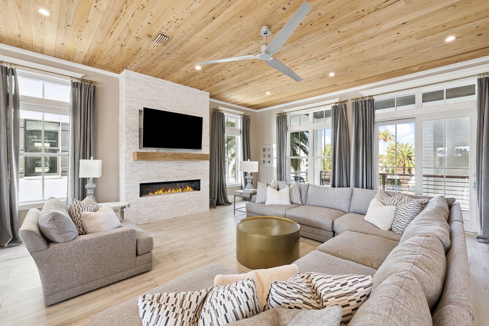 Unwind in your spacious living room with vaulted wood ceilings, cozy fireplace, and plush sectional seating perfect for family gatherings.