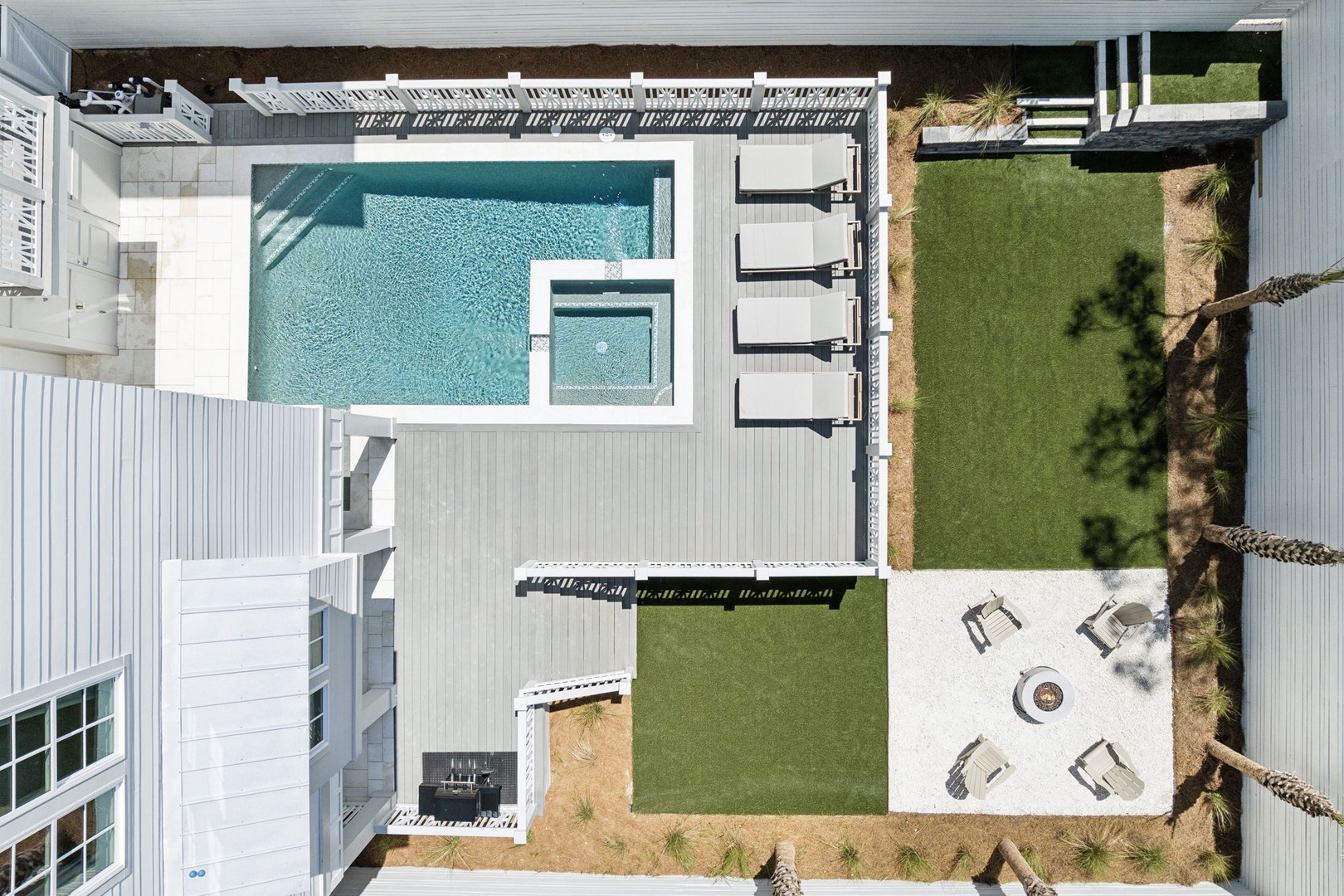 Stunning aerial view of this modern property showcasing the pristine pool area, manicured lawn, and elegant outdoor entertaining spaces.