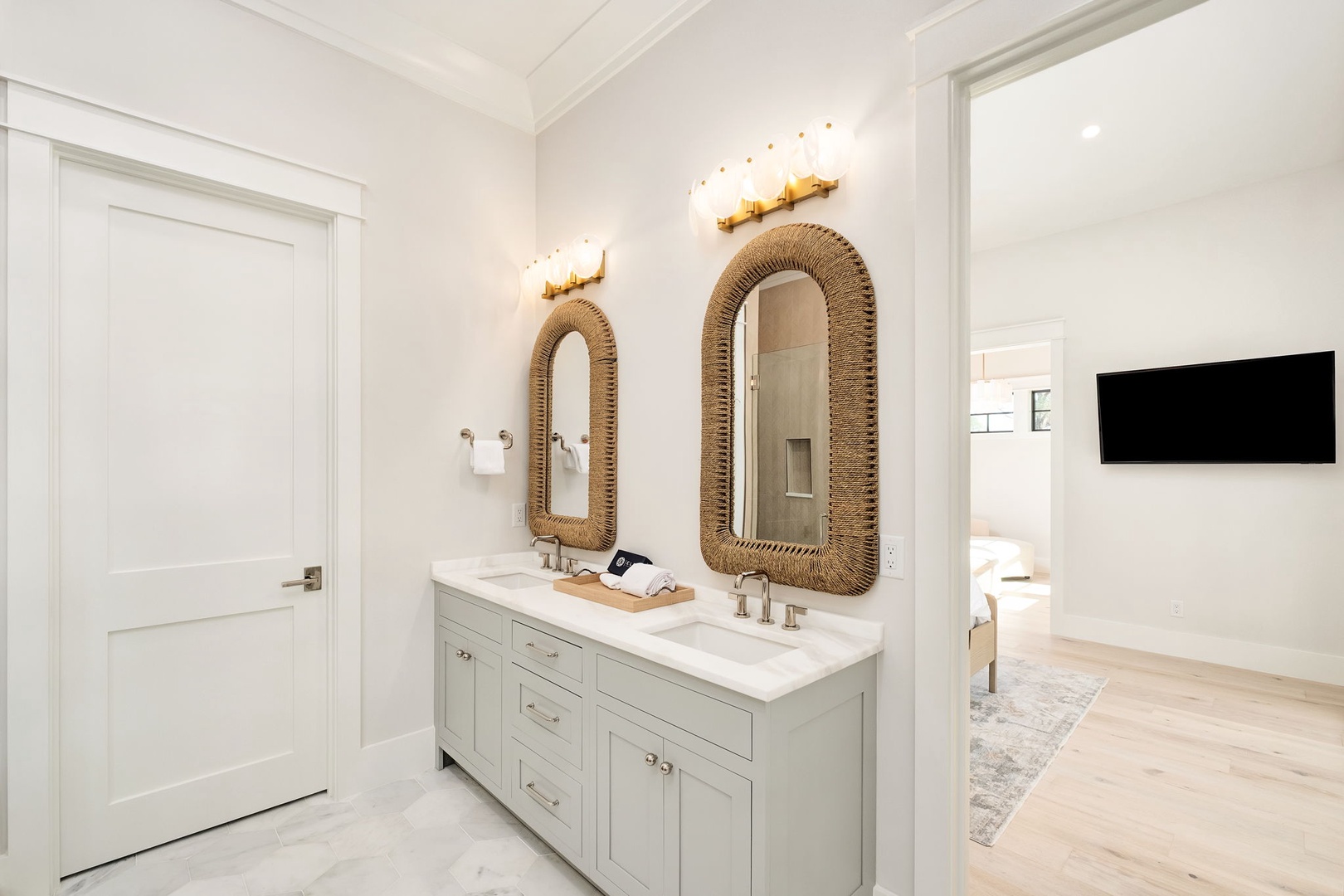 Indulge in your luxurious ensuite with dual vanities, elegant rope mirrors, and stunning marble floors that elevate your daily routine.