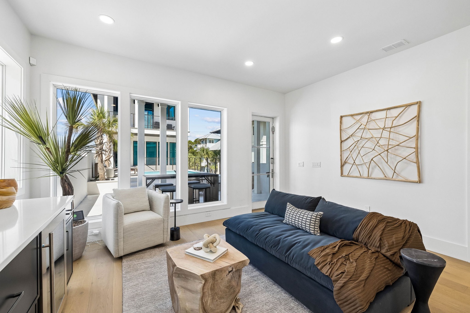 Sink into plush seating and unwind in your bright, modern living space. Natural light pours through French doors that open to your private balcony, inviting a seamless coastal lifestyle.