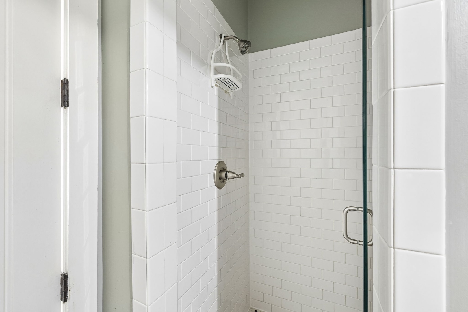 Step into your sleek walk-in shower with modern fixtures and crisp white subway tile—your perfect place to refresh and recharge after a day of adventure.