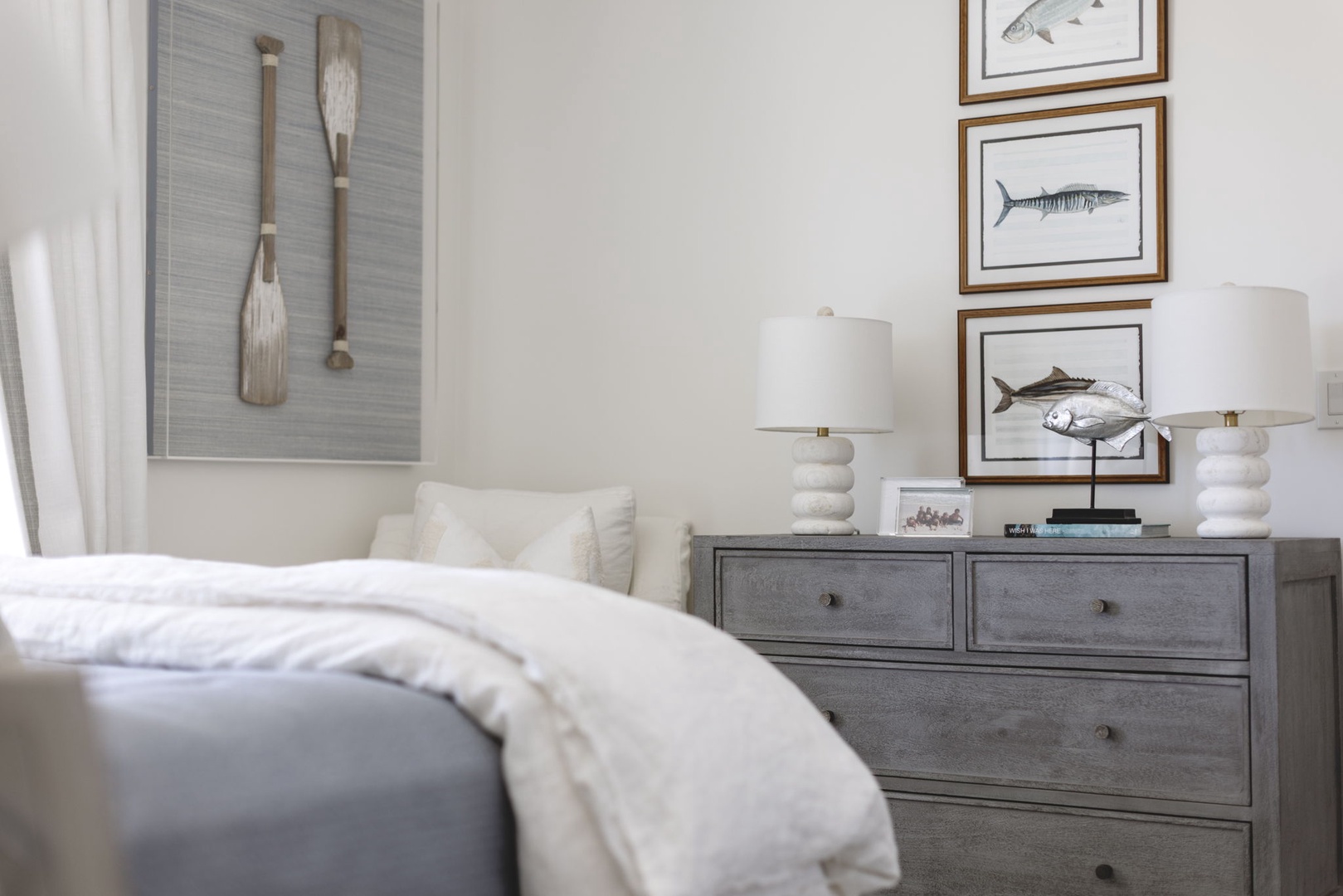 Your coastal retreat awaits with crisp linens, nautical artwork, and soft lamplight that brings serene beachside charm into every restful evening.