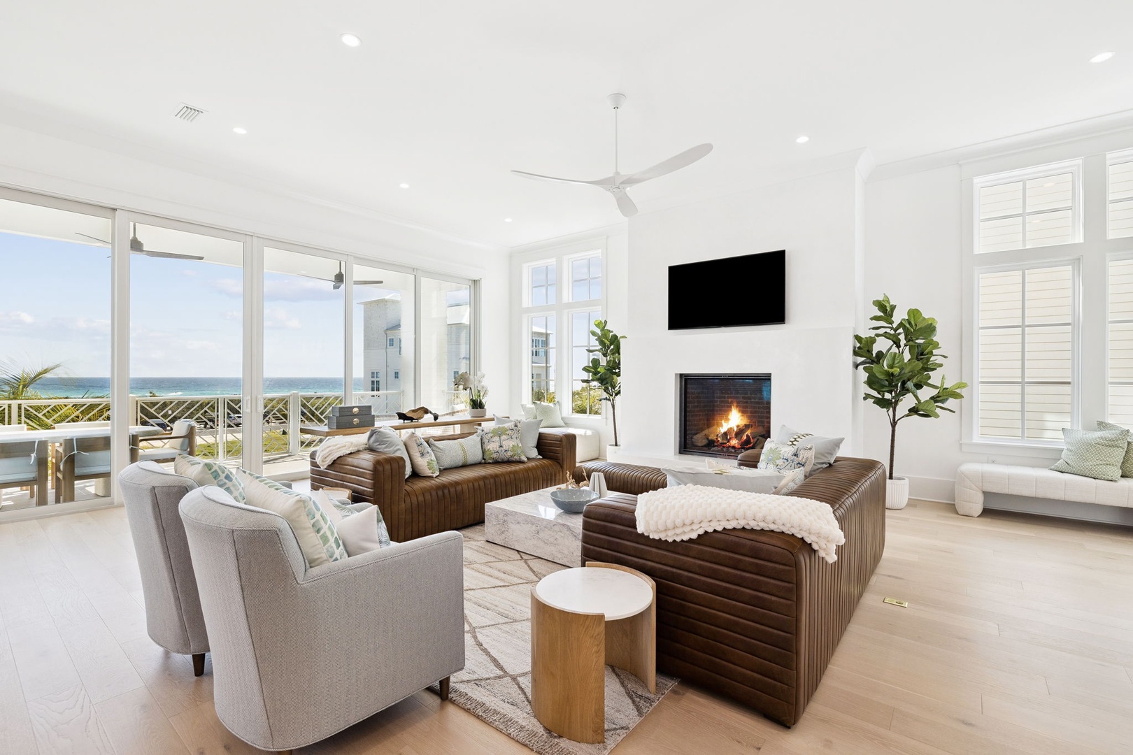 Unwind in this stunning oceanfront living room where natural light and sea breezes flow through floor-to-ceiling windows.