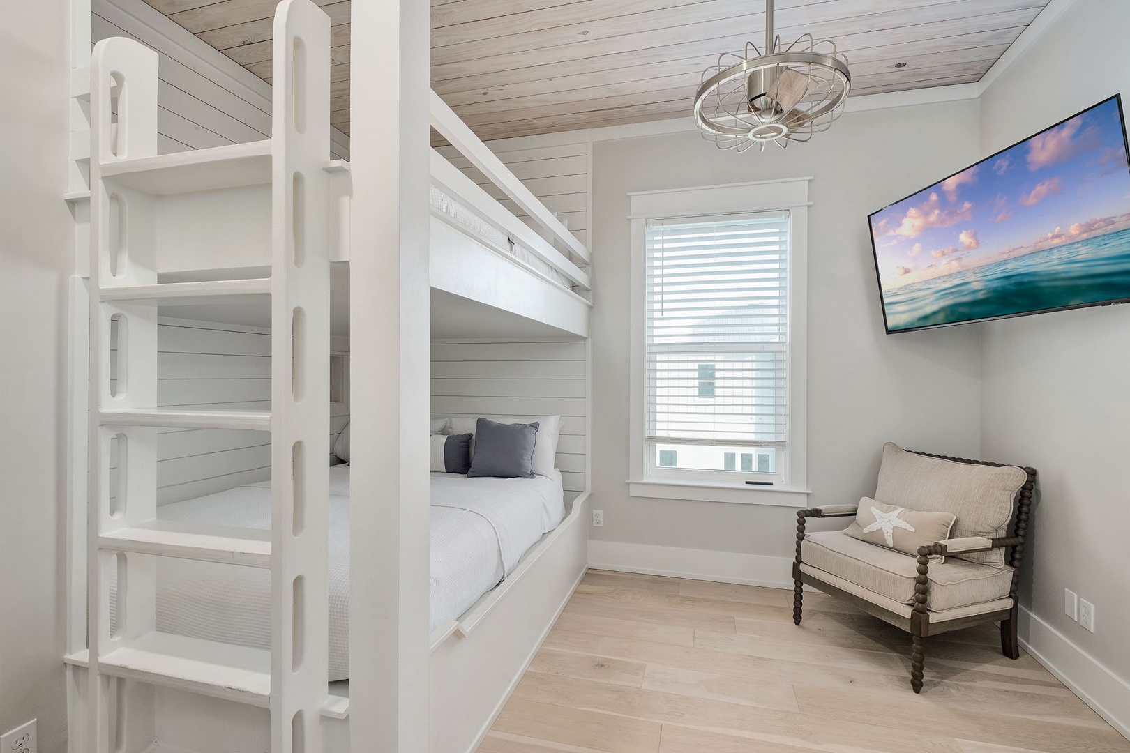 Drift off in your cozy bunk room, where coastal charm meets comfort with built-in beds and ocean views on the TV.