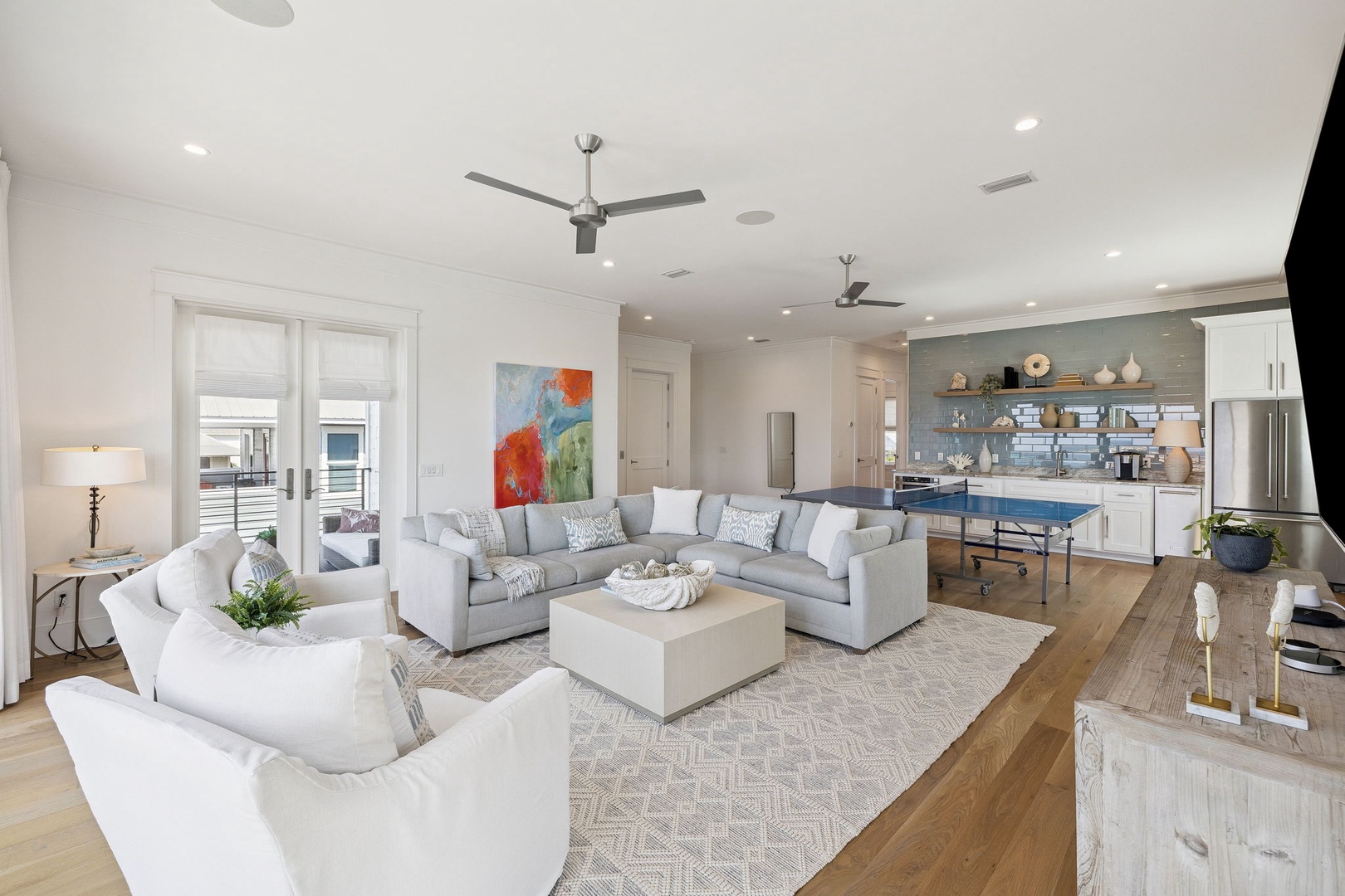 Relax in your spacious open-plan living area with plush sectional seating, modern kitchen, and stylish decor throughout.
