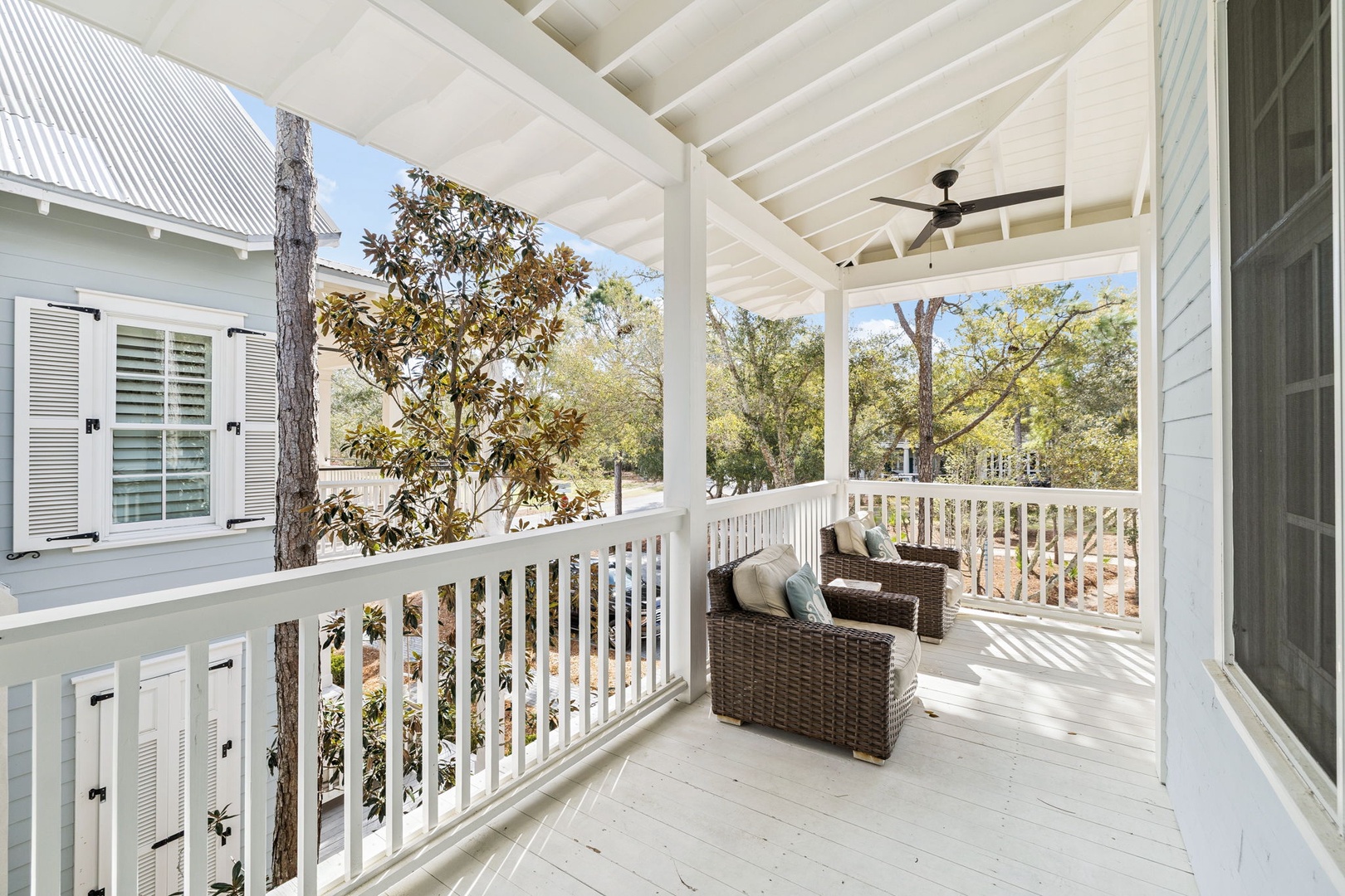 Step onto your private covered balcony and sink into comfortable wicker seating while enjoying peaceful tree-lined views and gentle afternoon breezes.