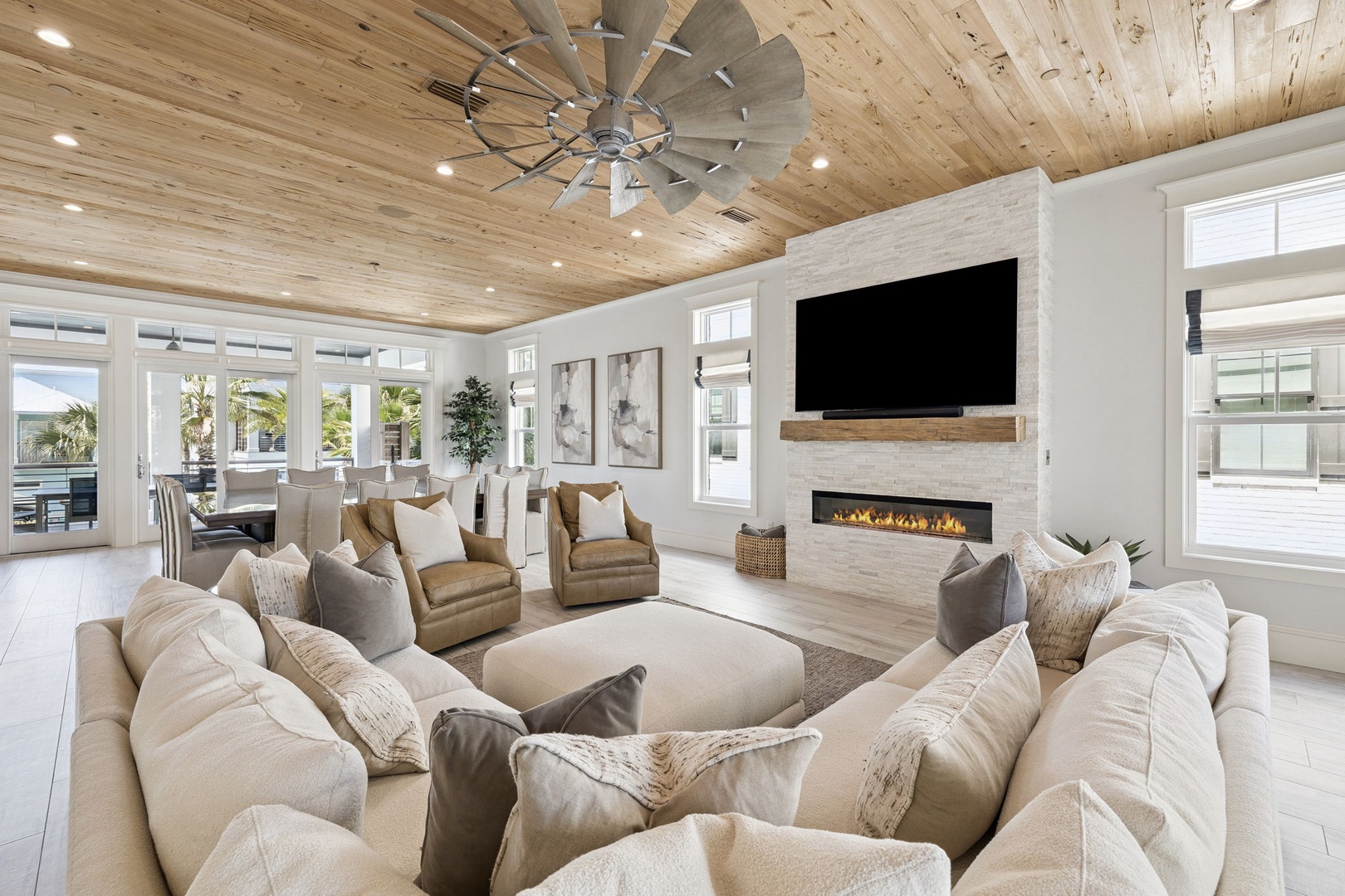 Sink into plush sectional seating where rustic wood meets modern elegance, with cozy fireplace warmth for perfect evening relaxation.