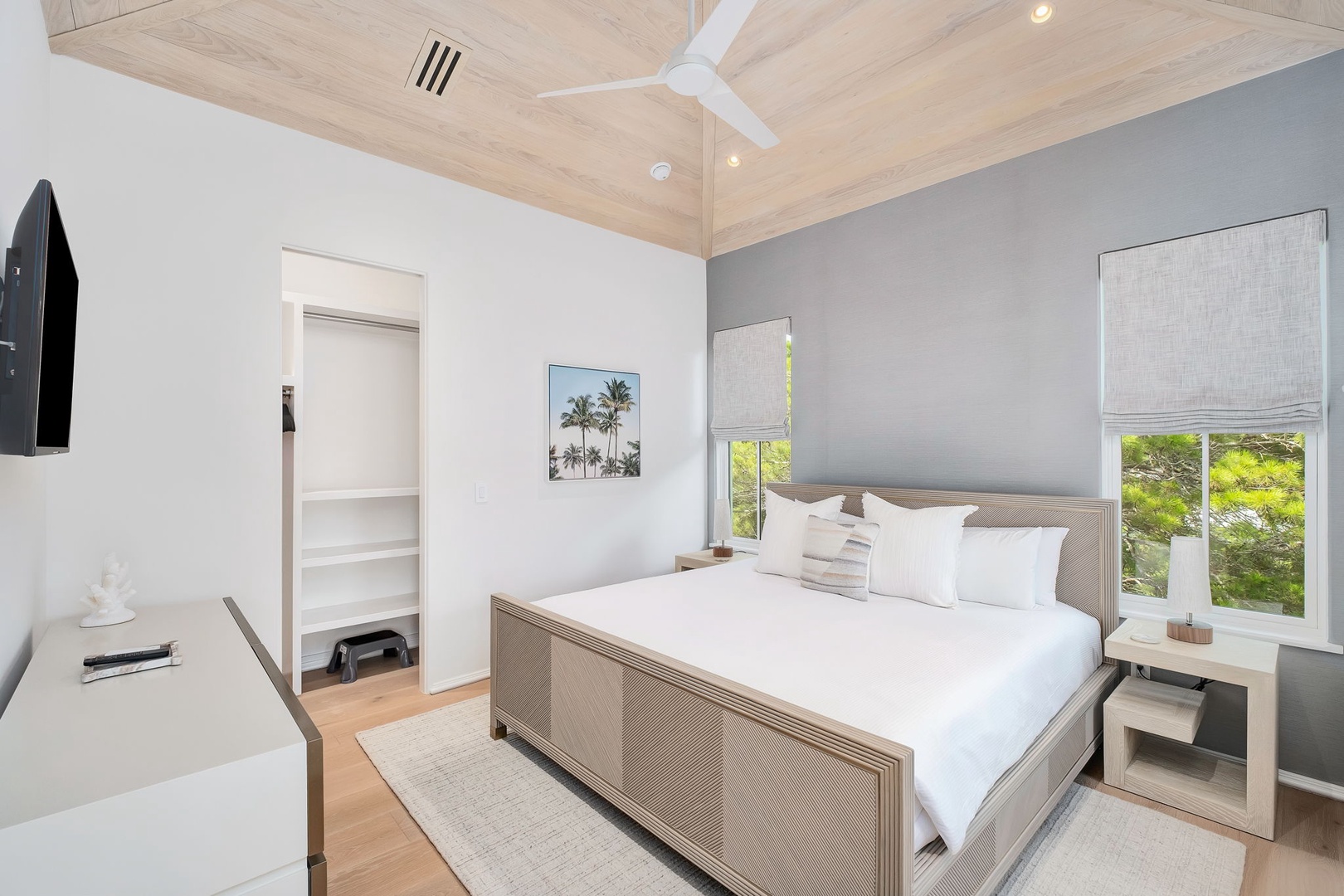 Drift off beneath the vaulted wood ceiling and gentle ceiling fan. Natural light and greenery greet you through the windows each morning, making your restful retreat feel both serene and uplifting.
