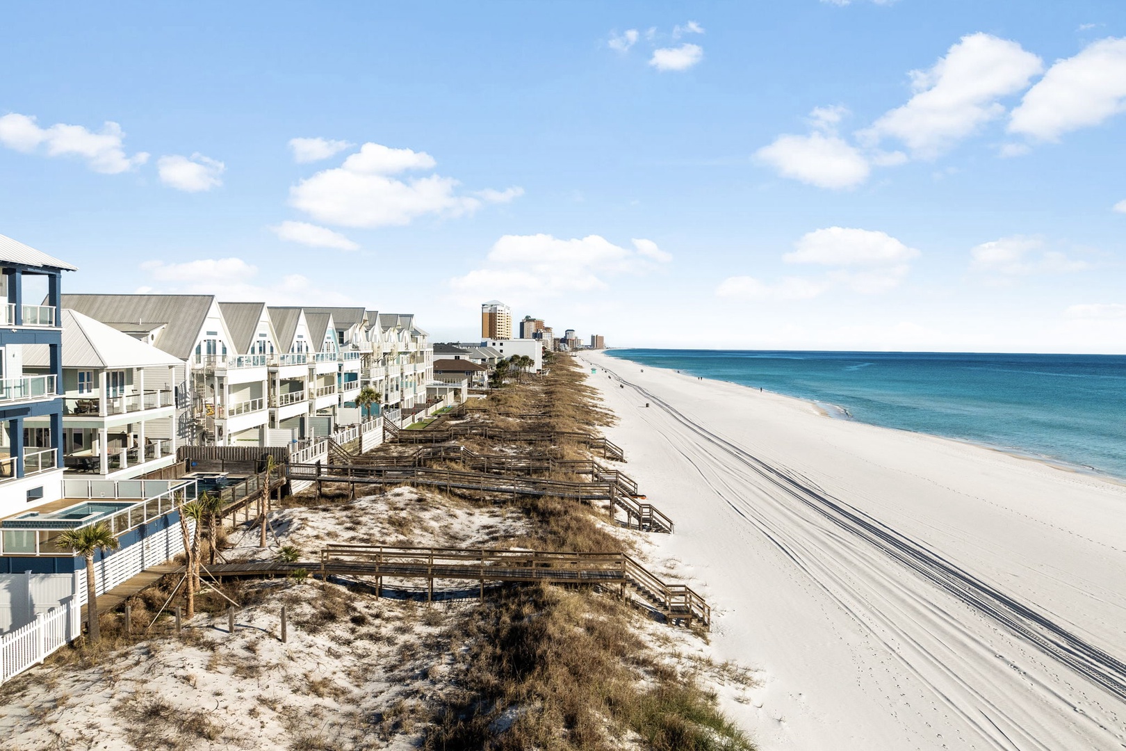 Stunning beachfront location with pristine white sand and turquoise waters just steps from charming coastal homes.