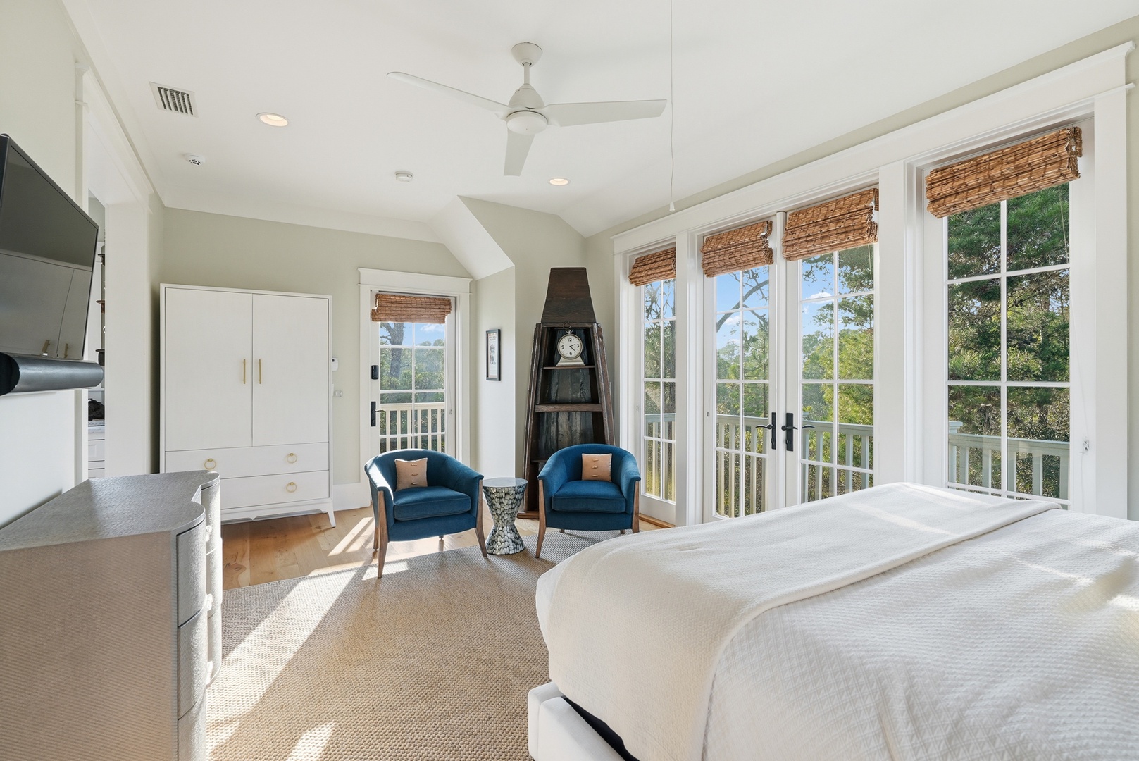 Wake up to natural light streaming through elegant French doors, where treetop views and coastal breezes await from your private balcony. Enjoy morning coffee in your cozy seating nook or unwind after a day of exploring.