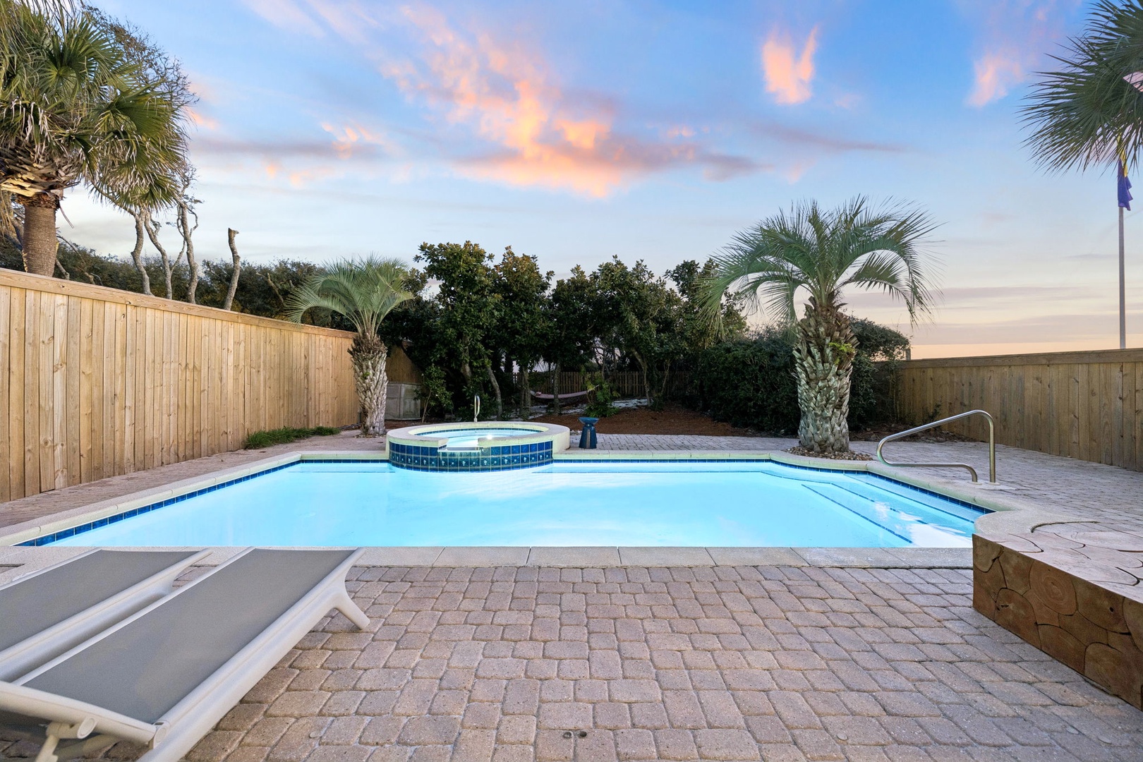 Private pool oasis with tropical palms creates your perfect sunset retreat for evening swims and poolside relaxation.