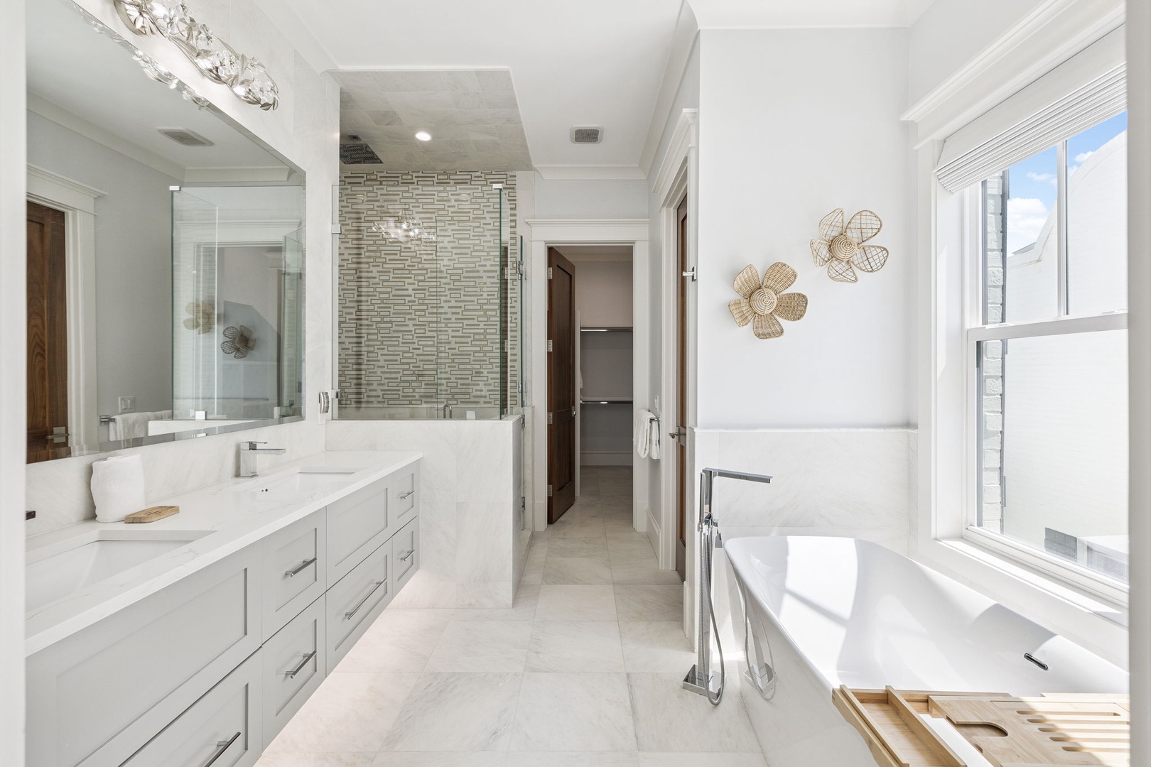 Indulge in your private spa-like sanctuary with elegant marble counters, a luxurious soaking tub, and sophisticated mosaic details for ultimate relaxation.
