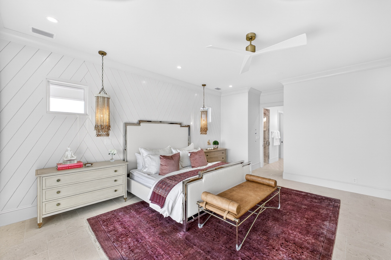 Sleep peacefully in your elegant bedroom with soaring ceilings, luxurious linens, and warm pendant lighting creating the perfect retreat.