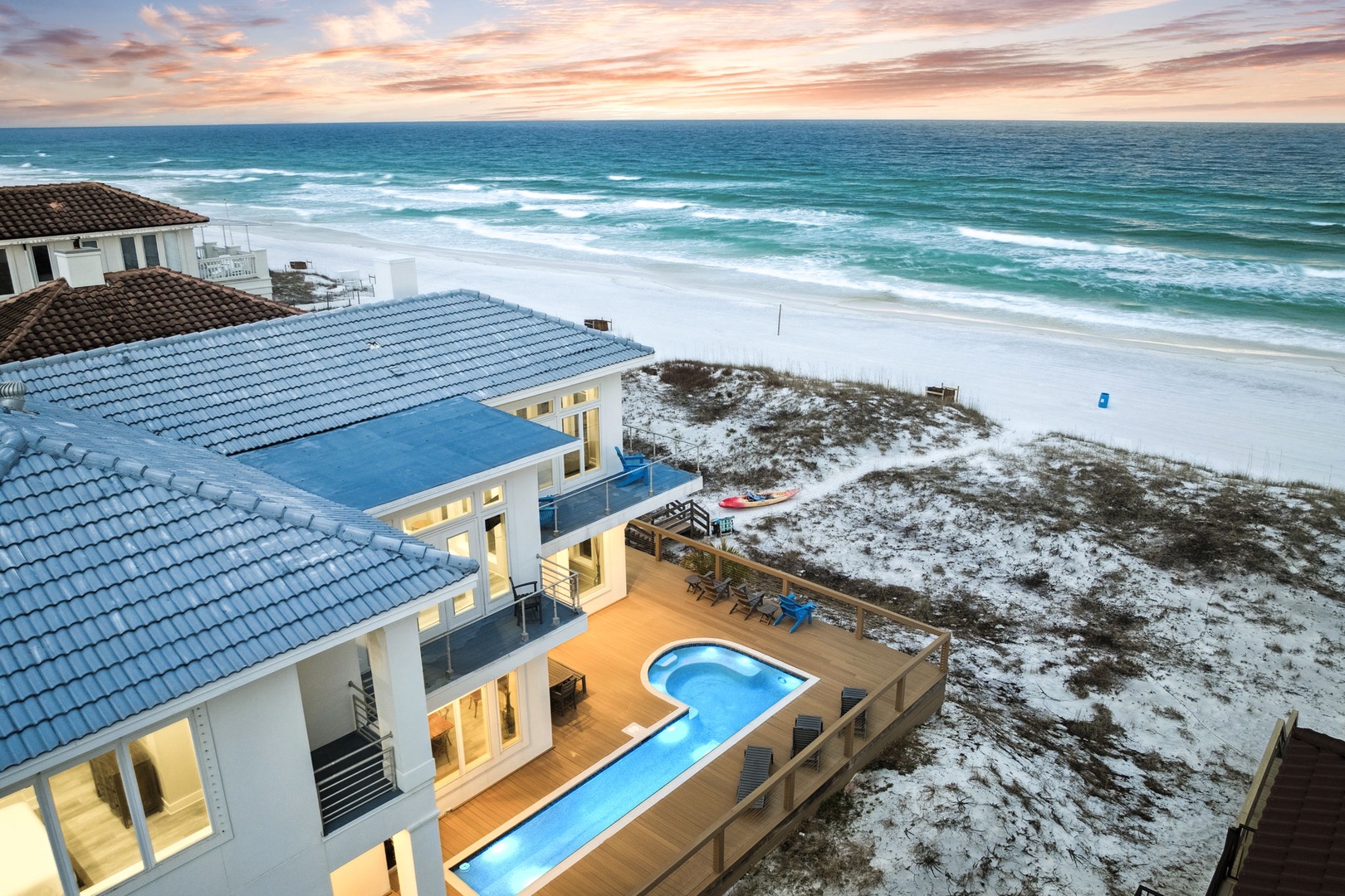 Stunning beachfront property overlooking pristine white sand and turquoise waters, featuring private pool and direct beach access.