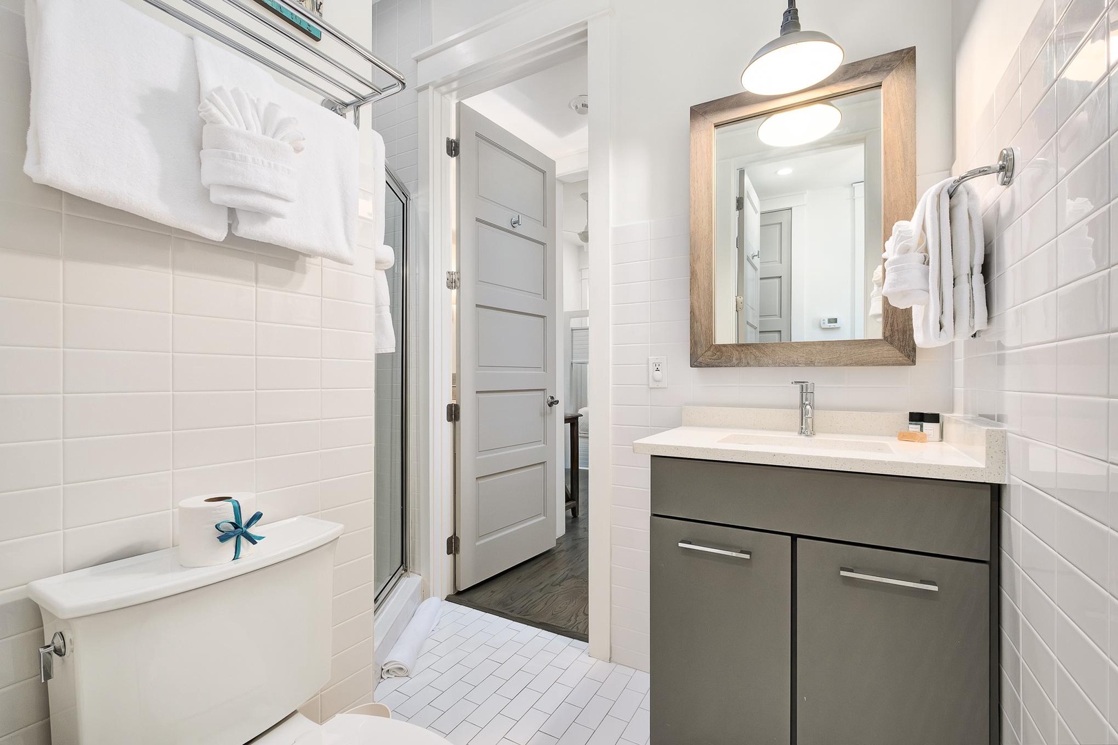 Sink into your own spa sanctuary with pristine white subway tiles, fluffy towels, and a luxurious soaking tub waiting for you.