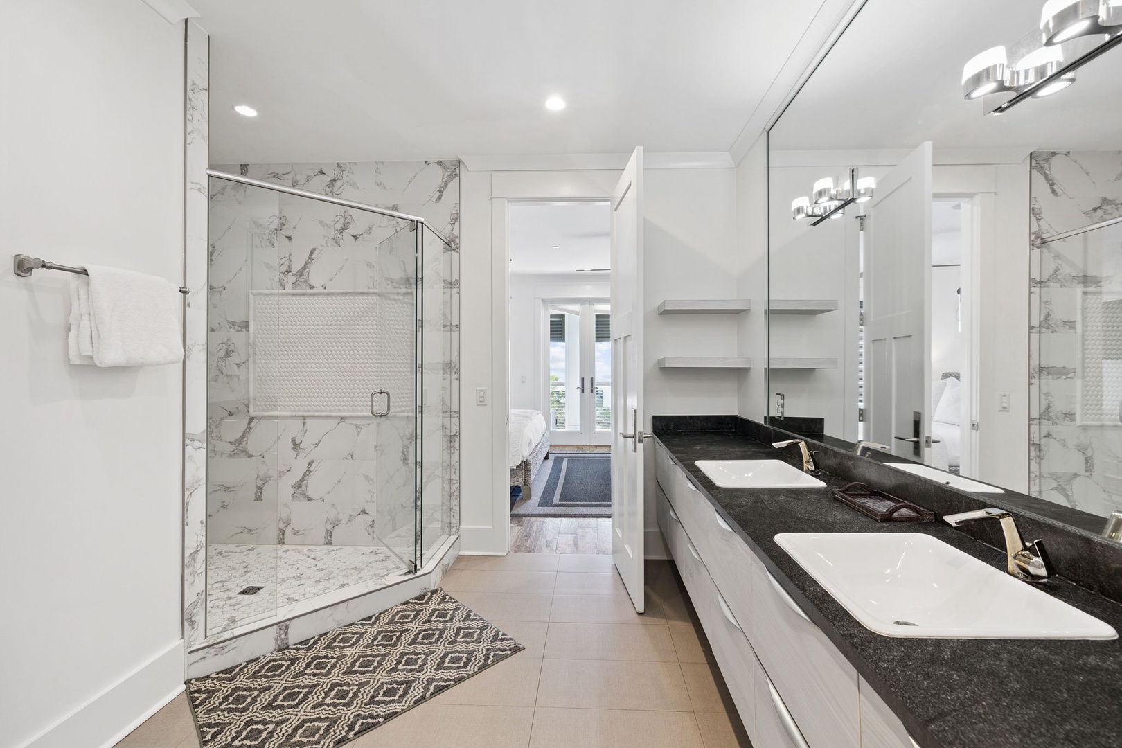 Indulge in your private spa-like retreat with luxurious marble finishes, rainfall shower, and elegant dual vanities.