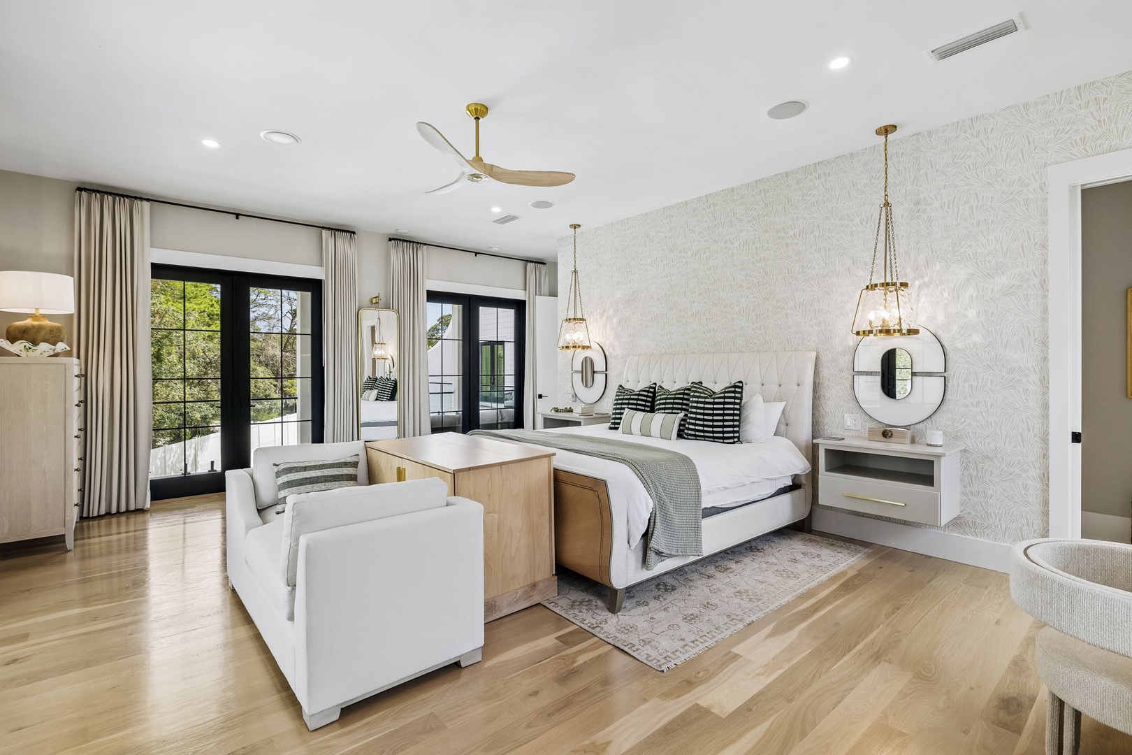 Sink into this serene retreat where natural light floods through French doors, luxurious linens await, and every detail invites you to unwind in sophisticated comfort.