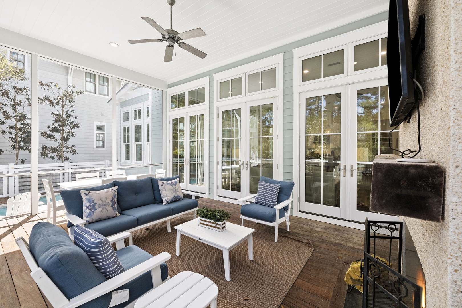 Unwind in your private screened porch with navy seating and fireplace warmth.
